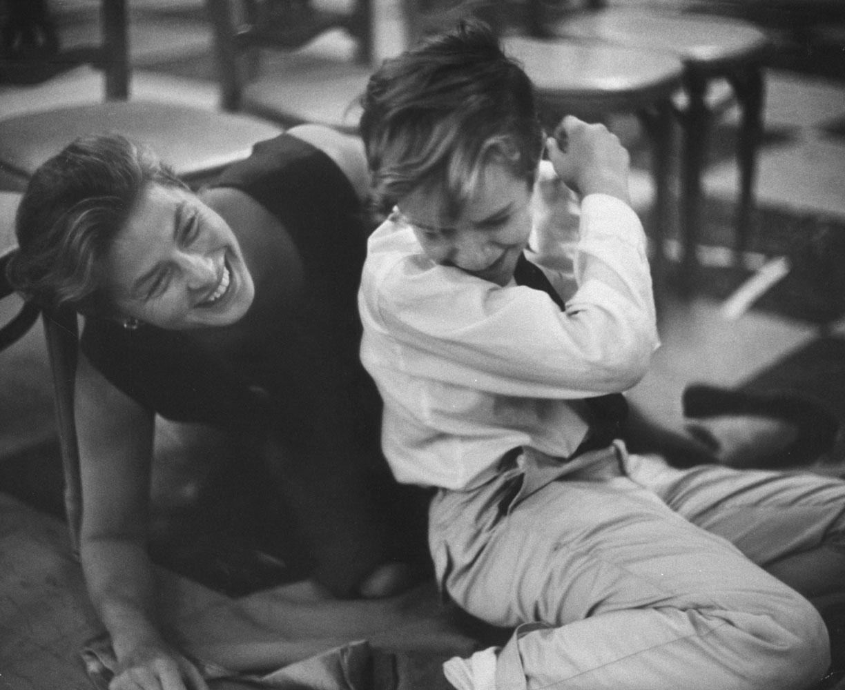 Ingrid Bergman plays with a child actor between scenes of the taping of John Frankenheimer's 1959 TV movie, The Turn of the Screw, for which she won an Emmy.