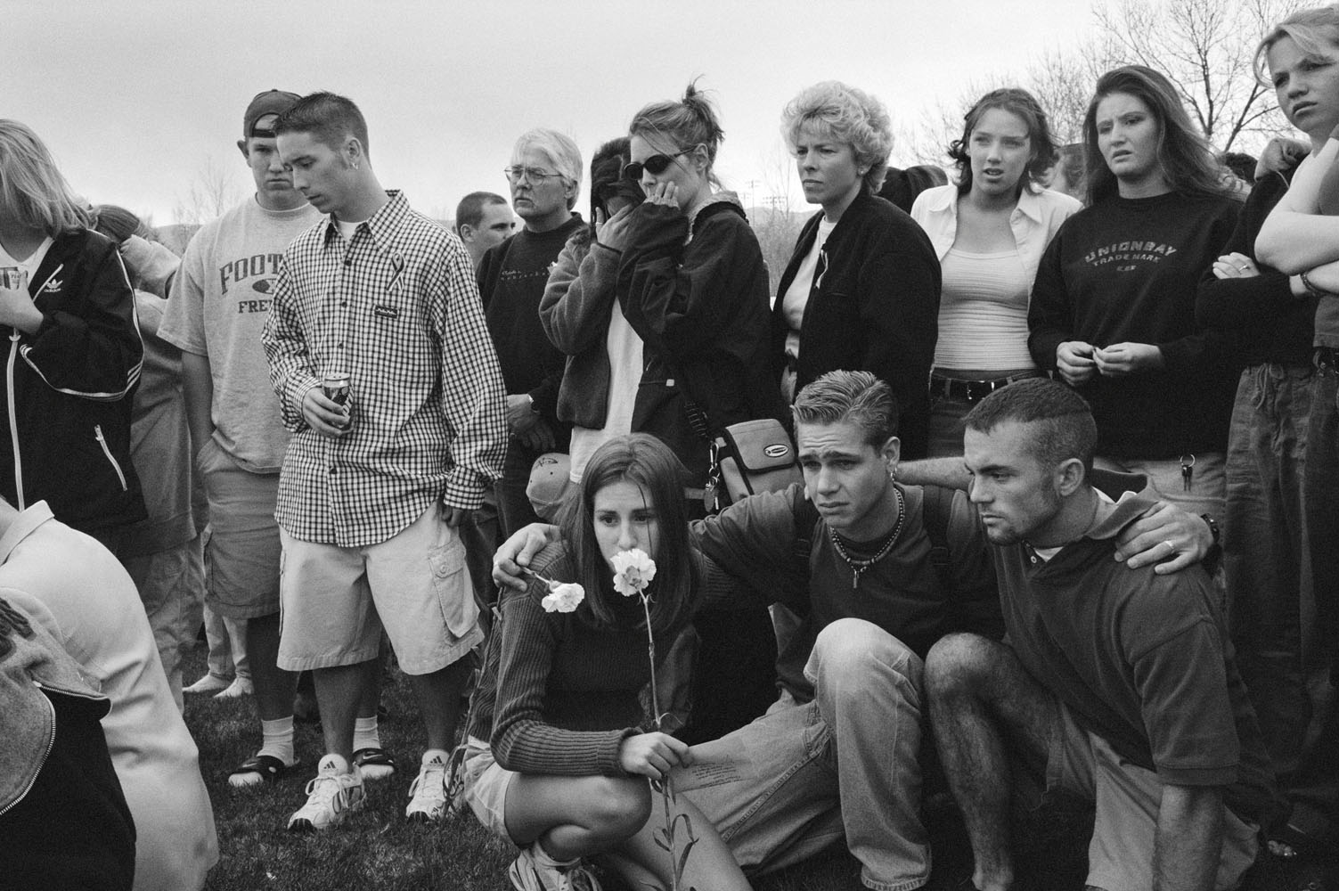 The day after the massacre, Columbine High School students gather outside their school to pray and place flowers on the ground. Many just wander among the tributes crying, trying to make sense of what has happened. (Zed Nelson—INSTITUTE)