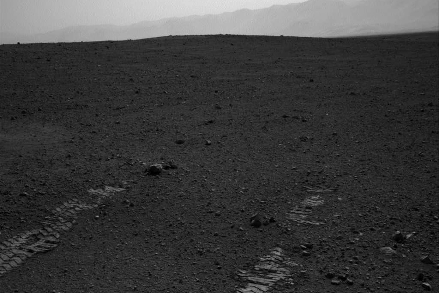 Aug. 22, 2012. This image shows the tracks left by NASA's Curiosity rover as it completed its first test drive on Mars.
