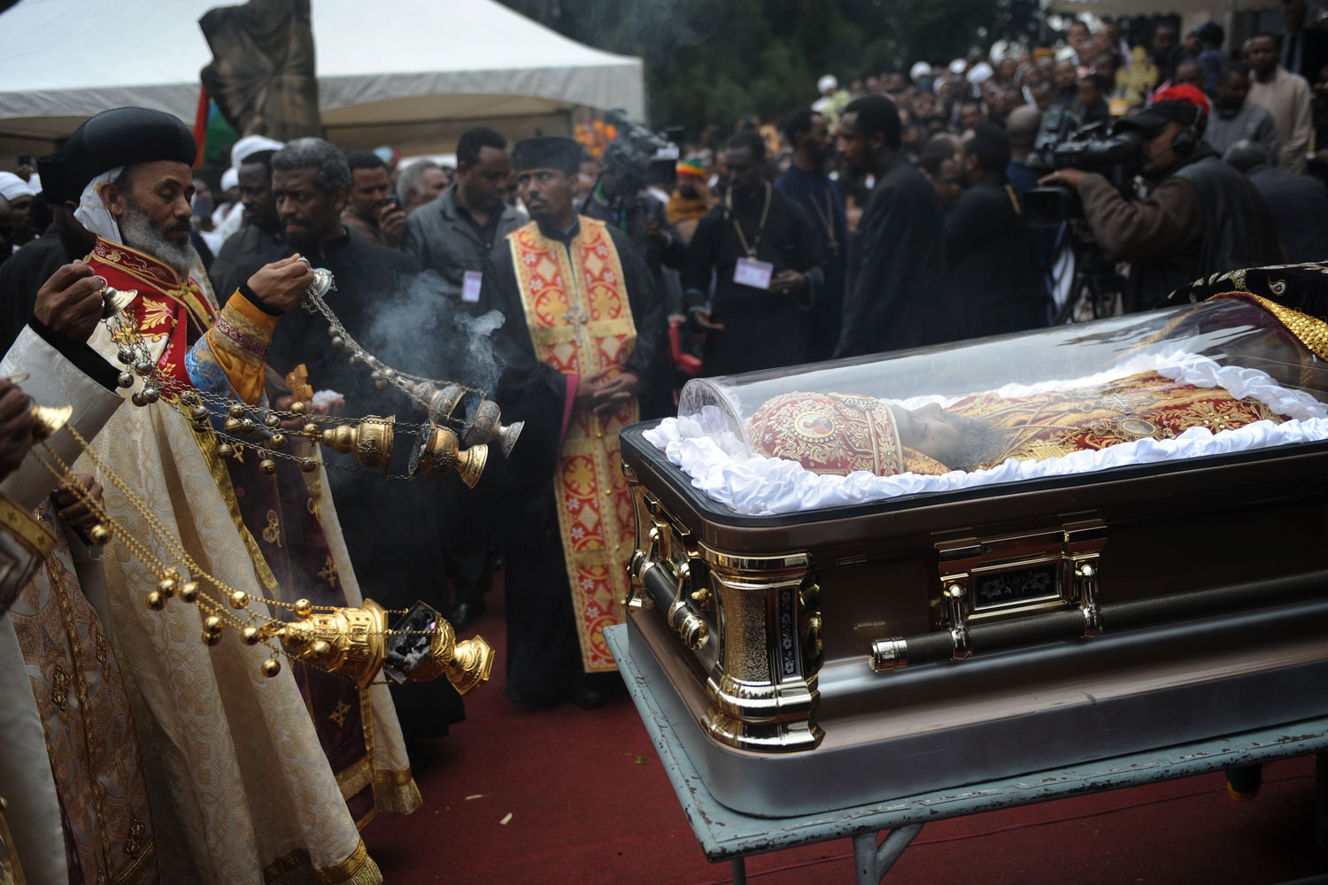 Aug. 23, 2012. Orthodox priests conduct a religious ceremony  next to the casket bearing the remains of Patriarch of the Ethiopian Orthodox Church, Abune Paulos, during his funeral at the St Selassie Orthodox church in Addis Ababa.