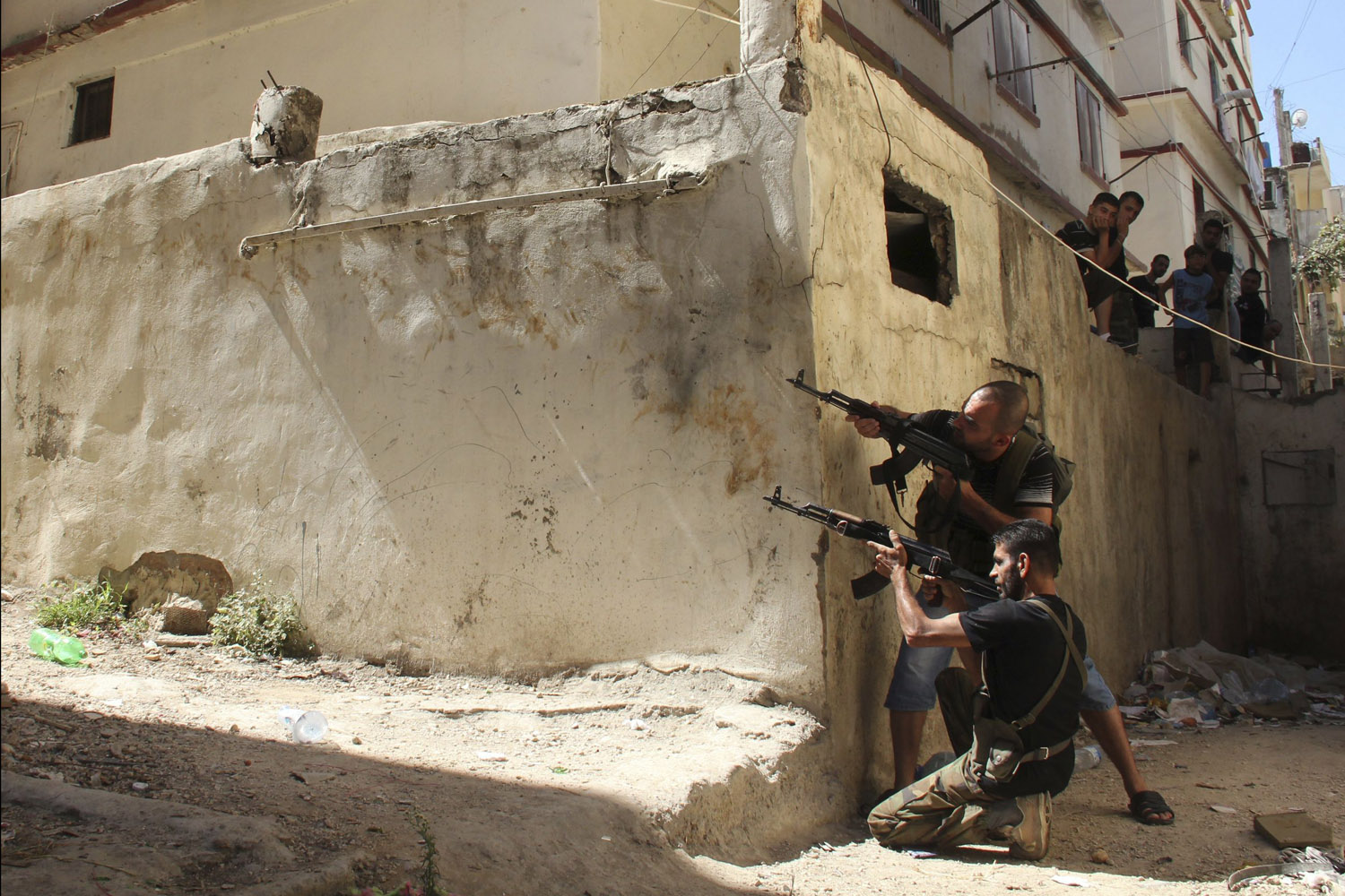 Aug. 22, 2012. Sunni Muslim gunmen aim their rifles from the Sunni Muslim-dominant neighbourhood of Bab al-Tebbaneh in Tripoli, northern Lebanon, during clashes between Sunni Muslims and Alawites.