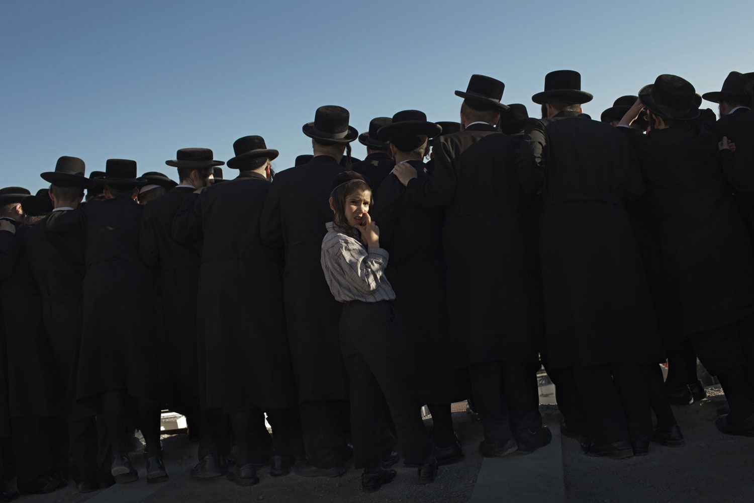 Aug. 23, 2012. Ultra-Orthodox Jewish men attend the funeral of Rabbi Abraham Chaim Roth on the Mount of Olives in Jerusalem.