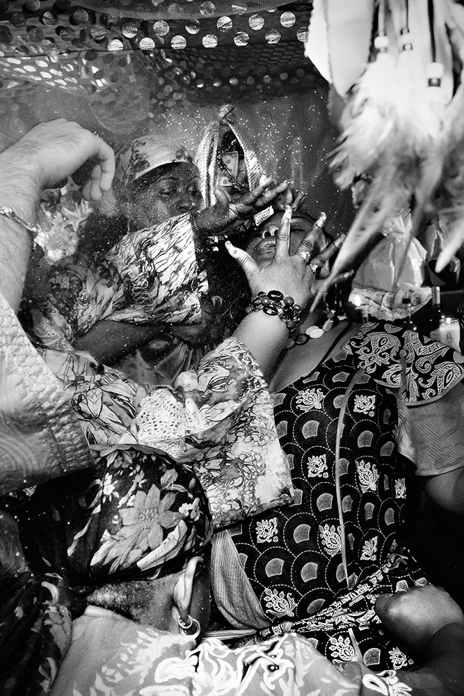 Mambo Rose Marie Pierre catches the Loa Erzulie Dantor during a feast arranged in the Loa's honor. 2011.