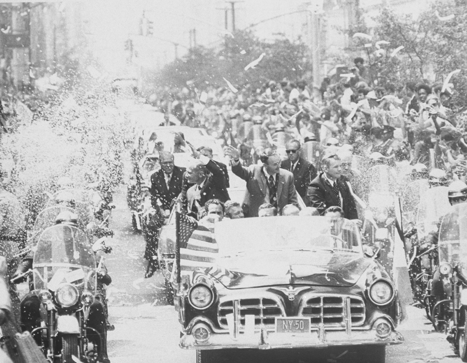 Apollo 11 astronauts Neil Armstrong, Buzz Aldrin and Michael Collins wave to crowds during a parade celebrating their return from the moon, August 1969.