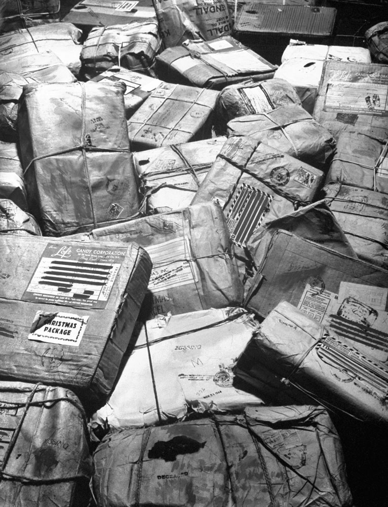 In New York City, piles of Christmas packages meant for American servicemen who have been listed as missing or killed in action await "return to sender" stamp, 1944.