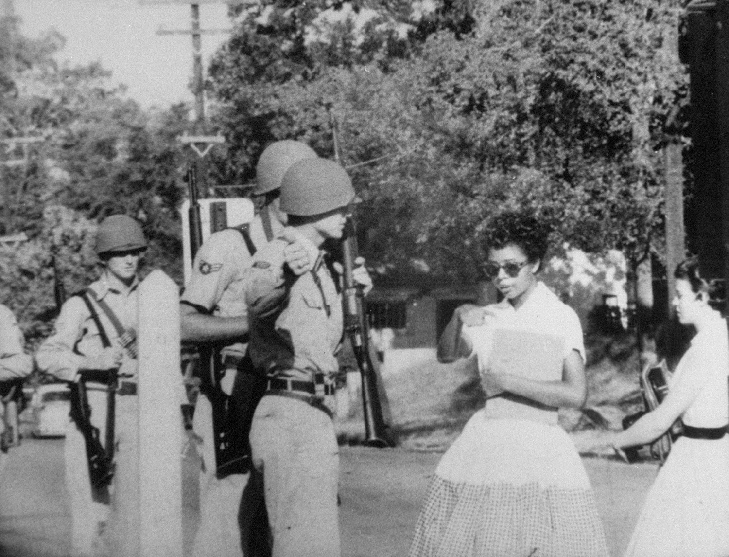Elizabeth Eckford, one of the Little Rock Nine, is waved off school grounds by Arkansas National Guardsmen, September, 1957.