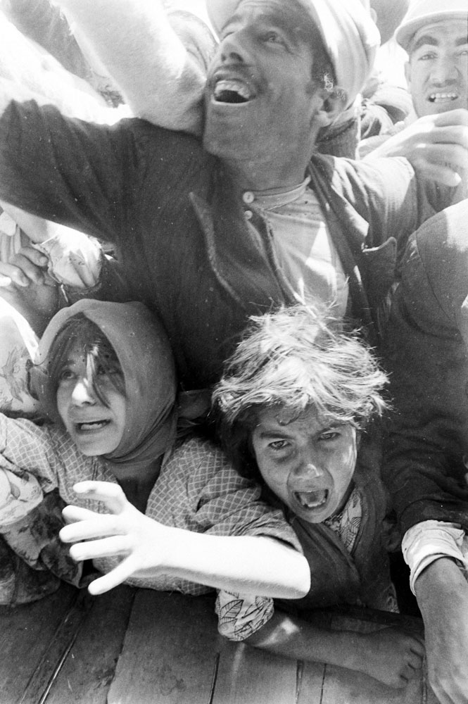 Survivors struggle for relief aid in the aftermath of a September 1962 earthquake in northwestern Iran.