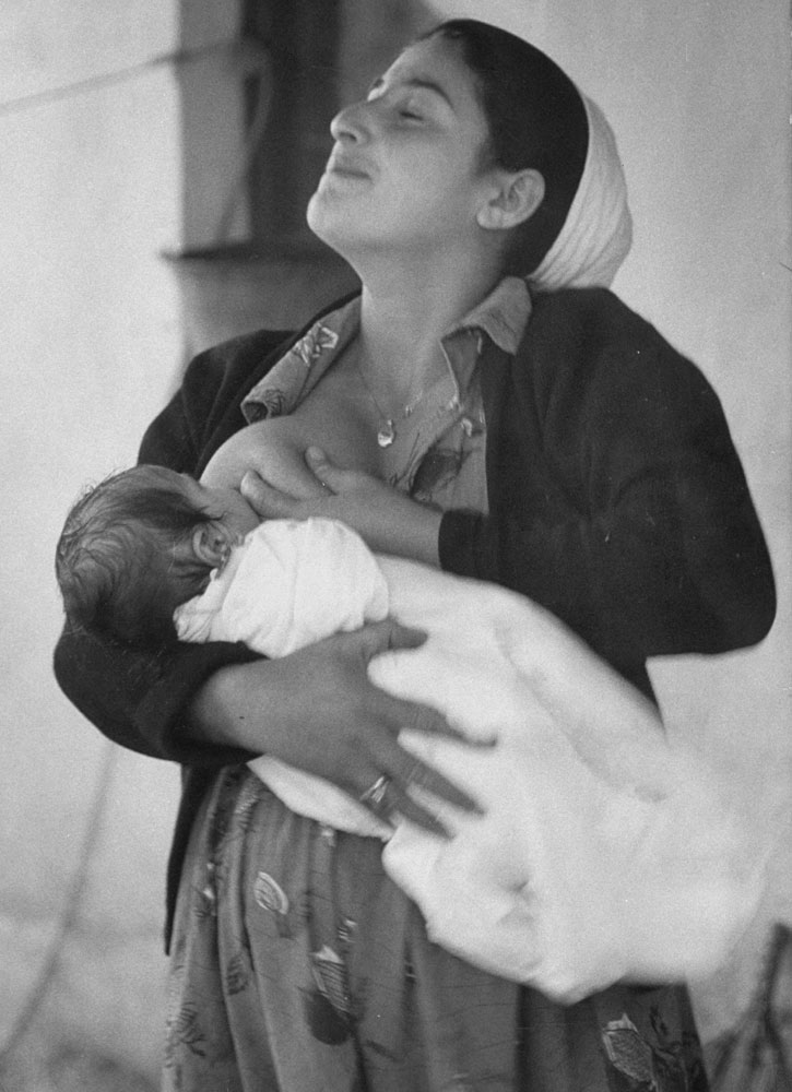 A mother nurses her child, Israel, 1960.