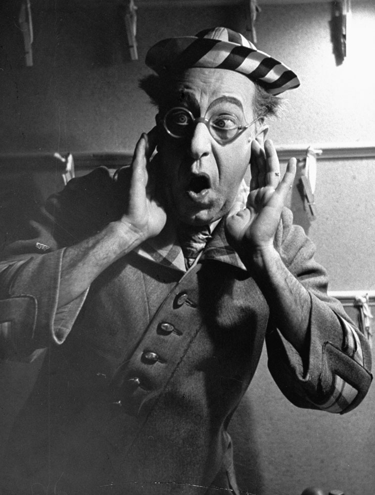 Comedian Ed Wynn looks horrified at the idea of killing worms in the Broadway show, Hooray for What!