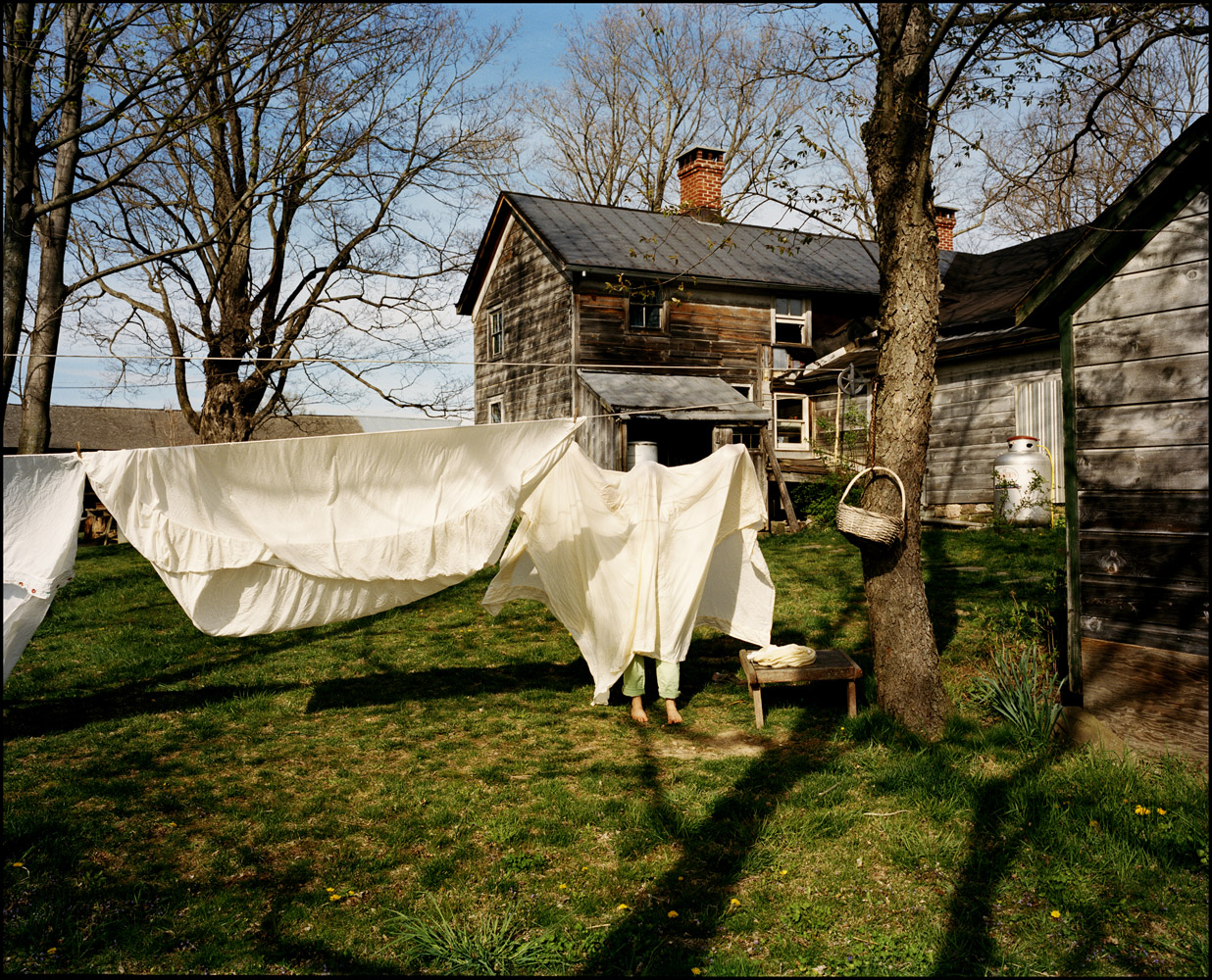 2007: Justin MaxonMarina Lopez, 21, hangs laundry out to dry on a horse farm outside of Gardiner, N.Y., as a strong wind wraps the bed sheet in her hands around her body. Lopez recently moved away from the farm, but she lived on it for over three years and it will always be home to her.
                               There are rare moments in one's life that can be placed in a glass bottle and later reveled as monumental in helping shape your present form. I hold the Eddie Adams Workshop in that place of reverence. The support system that began during that weekend, has contributed to the landscape of my career. I carry with me the countless relationships that, over the years, have lifted me up towards the heights of my aspirations.