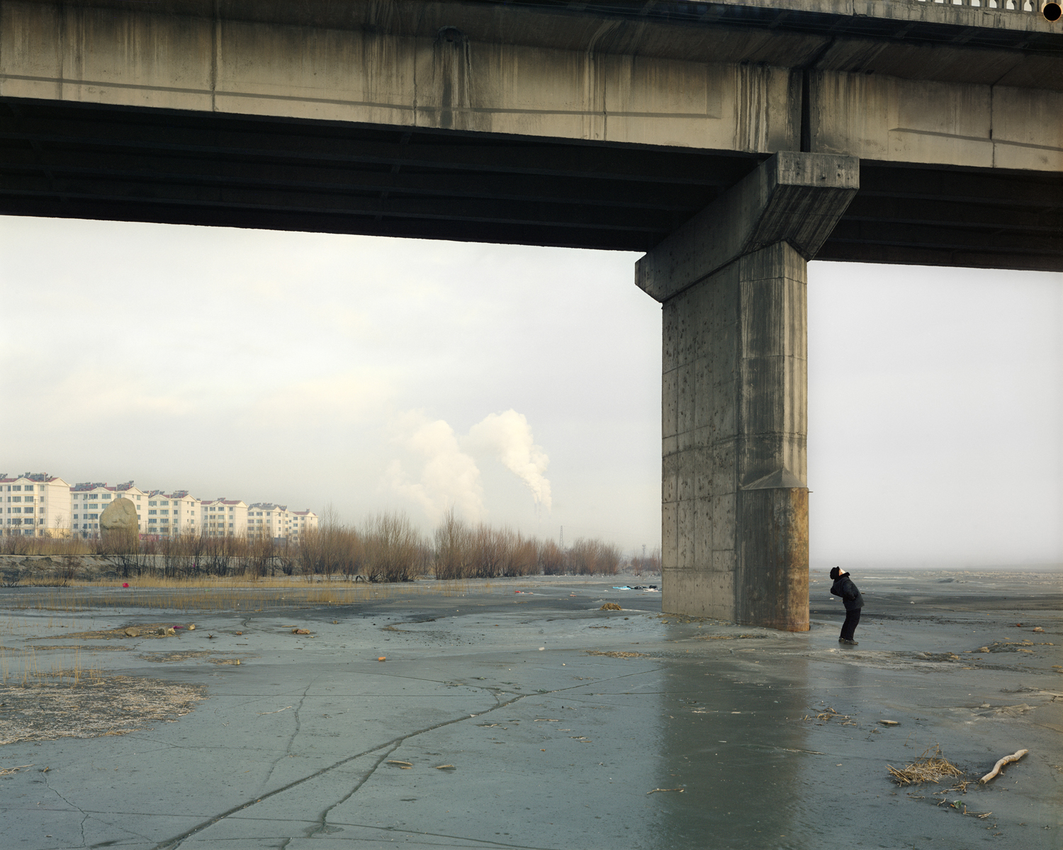 image: A man doing his morning exercises under the bridge, Ningxia province.