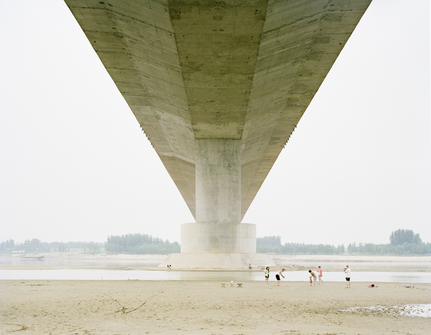 image: A family having fun under the bridge , Shandong province.