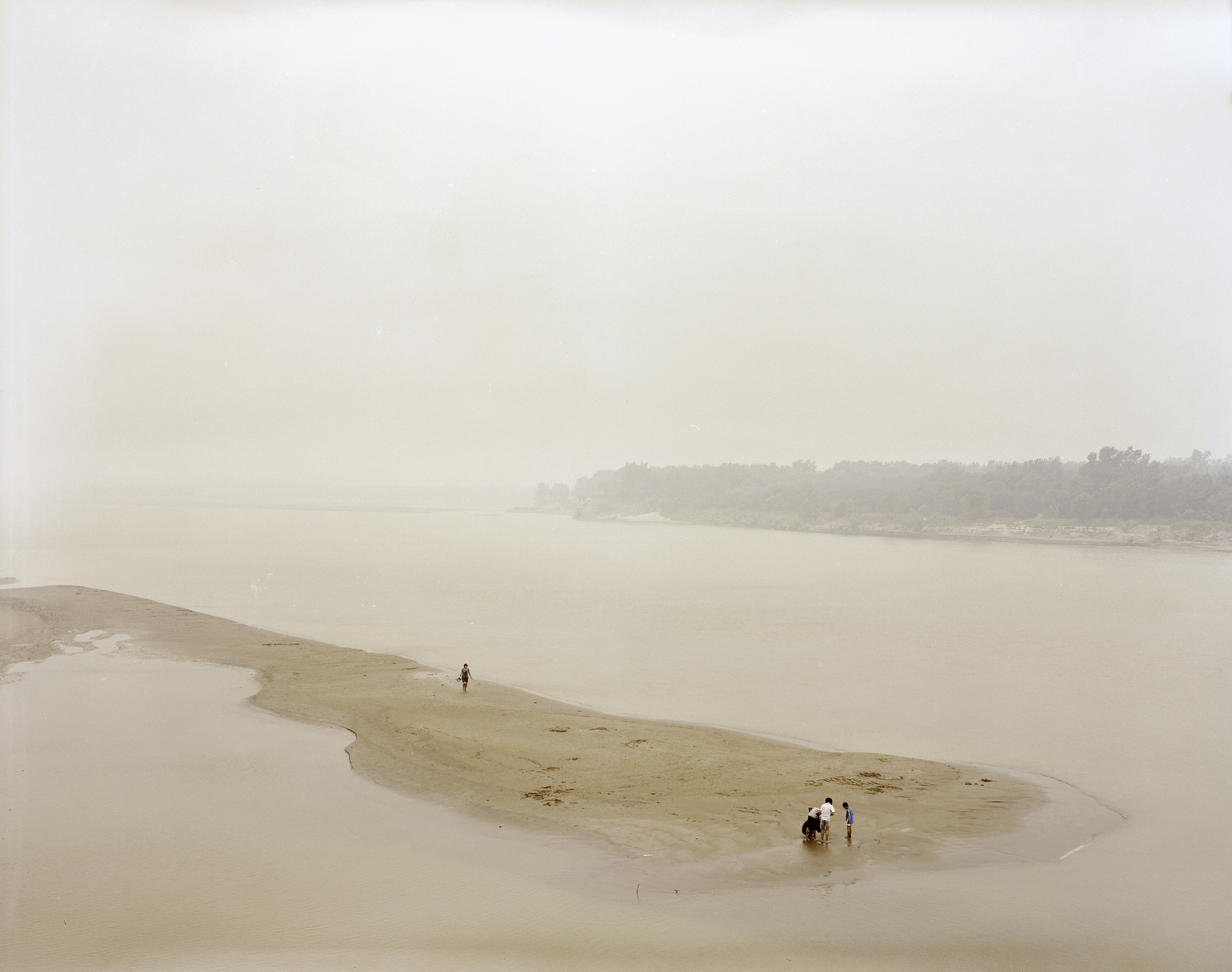 image: People playing in the riverbed, Shandong province.