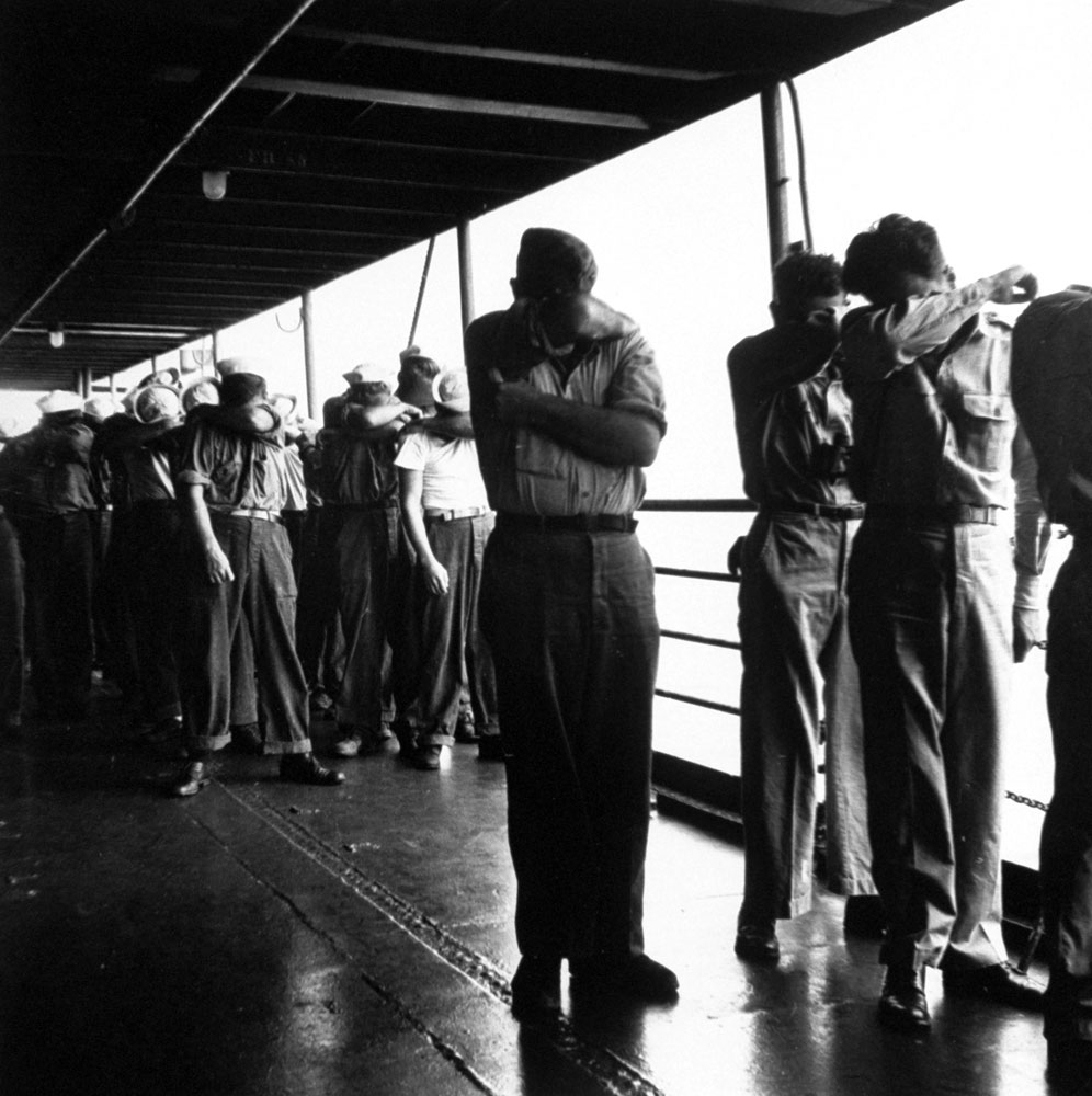 American sailors shield their eyes during a nuclear test at Bikini Atoll, July 1946.