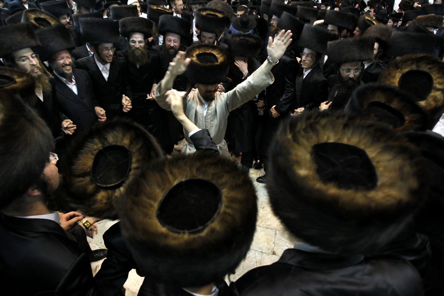 Oct. 8, 2012. Ultra-Orthodox Jewish men dance during Simhat Torah celebrations in Jerusalem's Mea Shearim neighborhood. The worshipers are marking the end of the annual cycle of the reading of the Torah and the beginning of the next cycle.