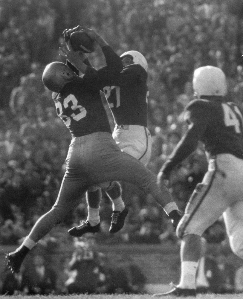 Notre Dame's Bill Wightkin leaps to snatch a 44-yard toss against Tulane, 1949.