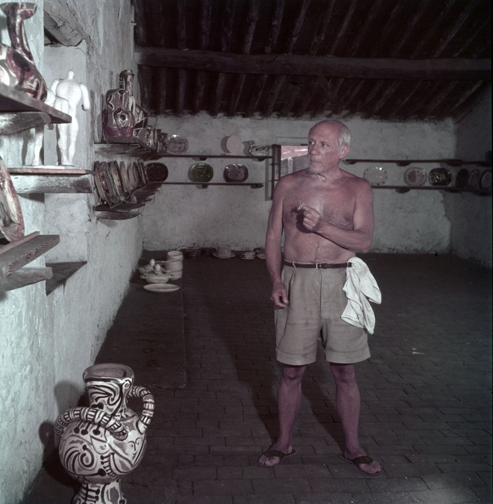 Pablo Picasso in a room displaying his pottery work, Vallauris, France, 1949.