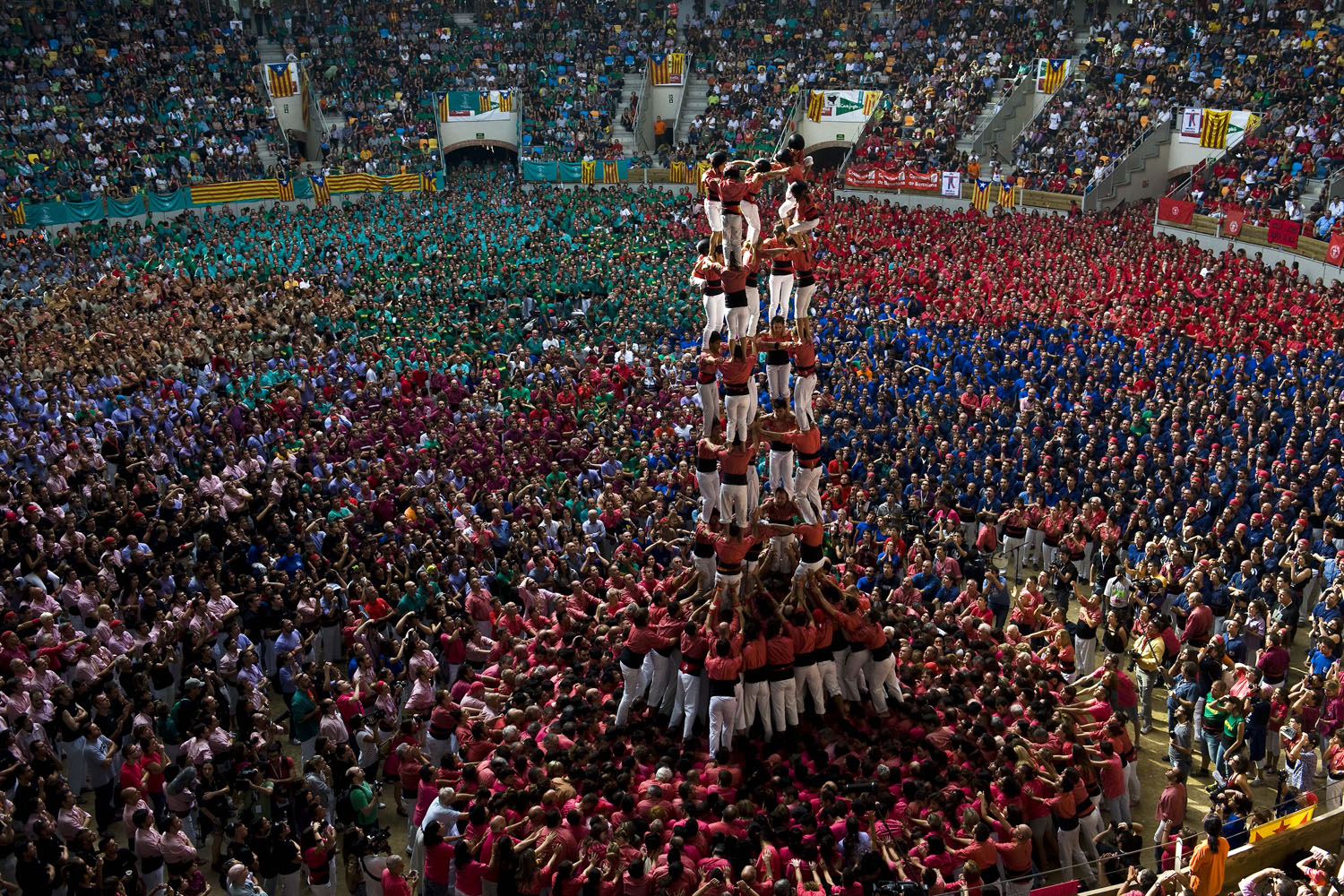 Oct. 7, 2012. Members of the Colla 'Vella de Valls' climb as they construct a human tower during the 24th Tarragona Castells Comptetion in Tarragona, Spain. The 'Castellers' who build the human towers with precise techniques compete in groups, known as 'colles', at local festivals with aim to build the highest and most complex human tower.