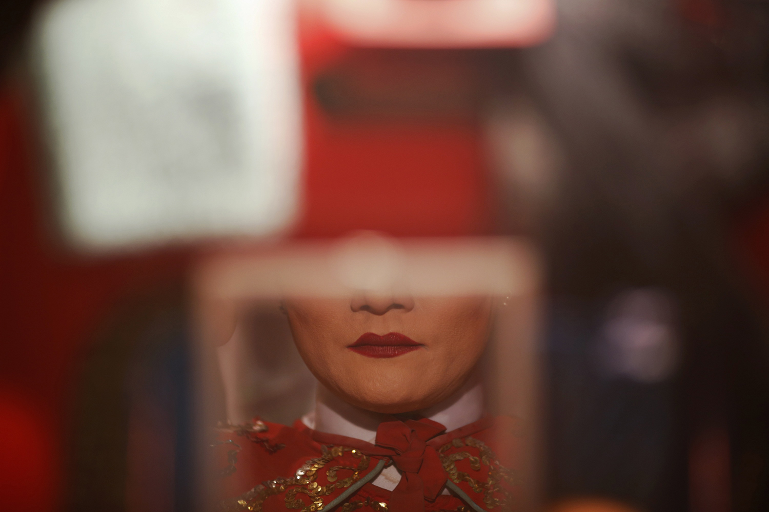 Image: Oct. 19, 2012. A Chinese opera actress is reflected in a mirror before performing outside a shrine during the annual vegetarian festival in Phuket, Thailand. The festival celebrates the local Chinese community's belief that abstinence from meat and various stimulants during the ninth lunar month of the Chinese calendar will help them obtain good health and peace of mind.