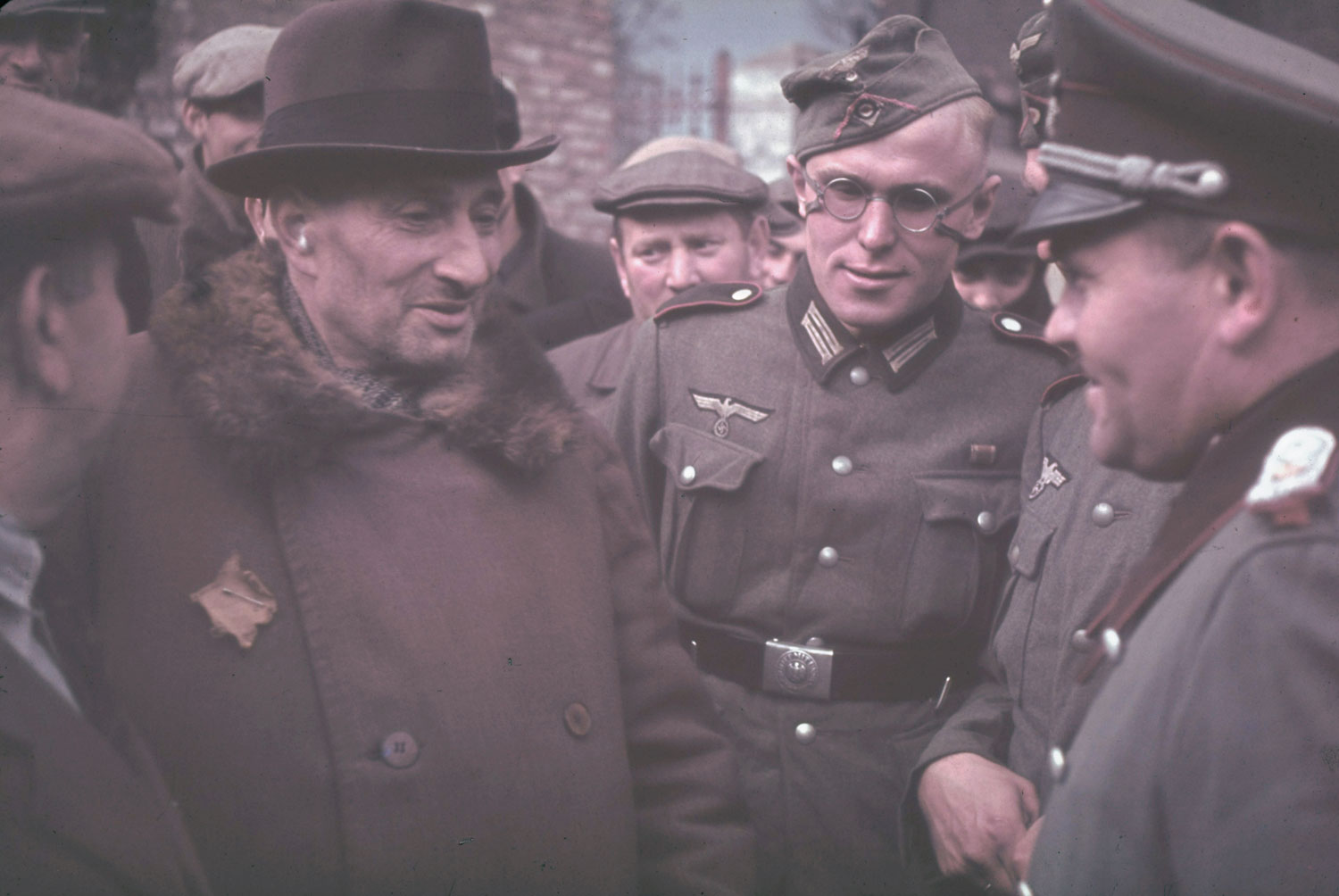 Elderly Jewish man speaks with German officers rounding up Kutno Jews, German-occupied Poland, 1939.