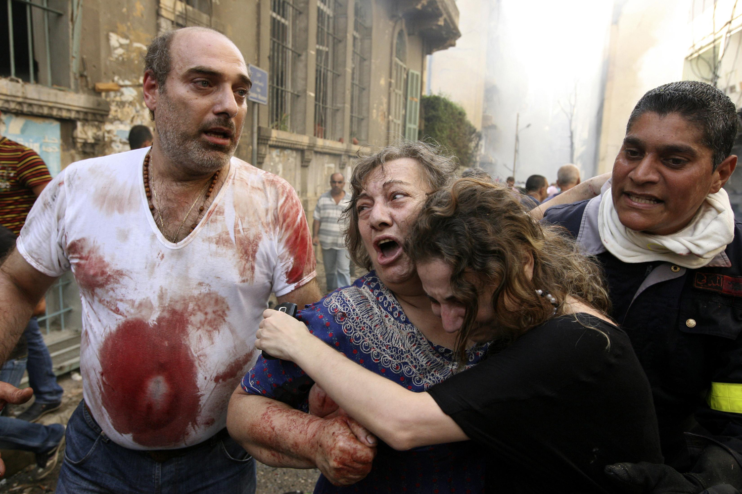Image: Oct. 19, 2012. Relatives comfort a wounded woman at the site of an explosion in Beirut. A huge car bomb exploded in central Beirut during rush hour killing at least two people and wounding 46, witnesses and security sources said.