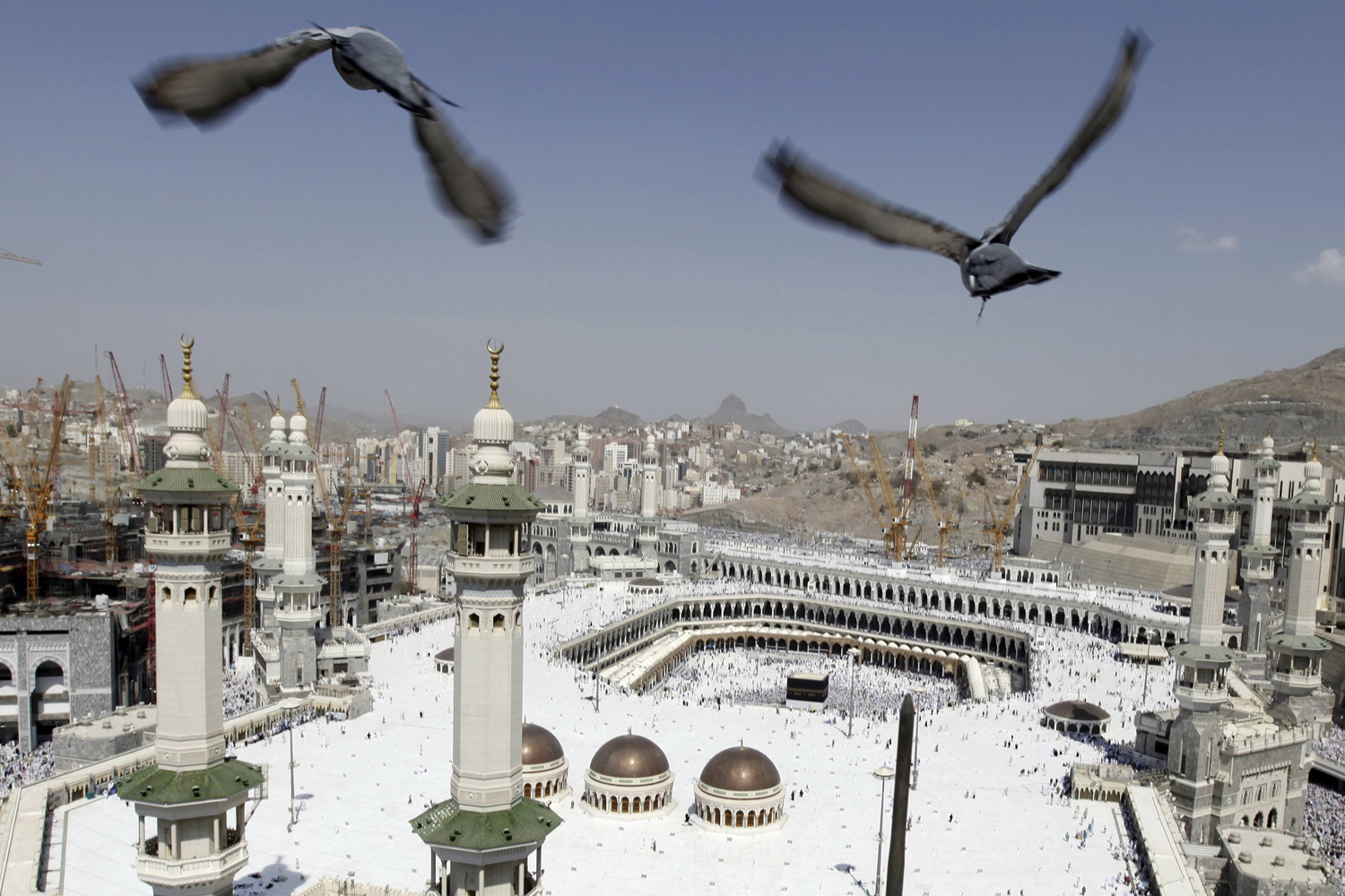 Image: Oct. 19, 2012. Pigeons fly over the Grand Mosque at Friday prayers during the annual haj pilgrimage in the holy city of Mecca, Saudi Arabia.