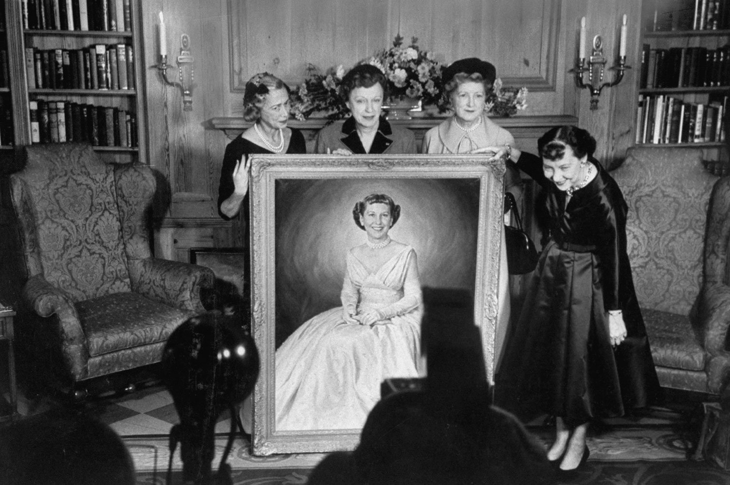 First Lady Mamie Eisenhower with a portrait of herself in her inauguration ball dress, given to her by husband, Dwight D. Eisenhower for her 60th birthday, 1956.