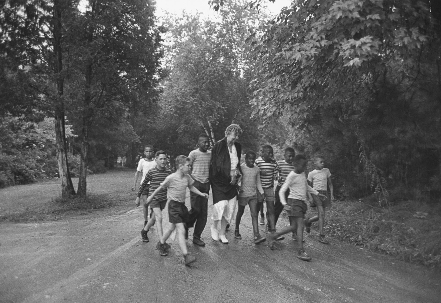 Former First Lady Eleanor Roosevelt walks with children en route to a picnic, 1948.