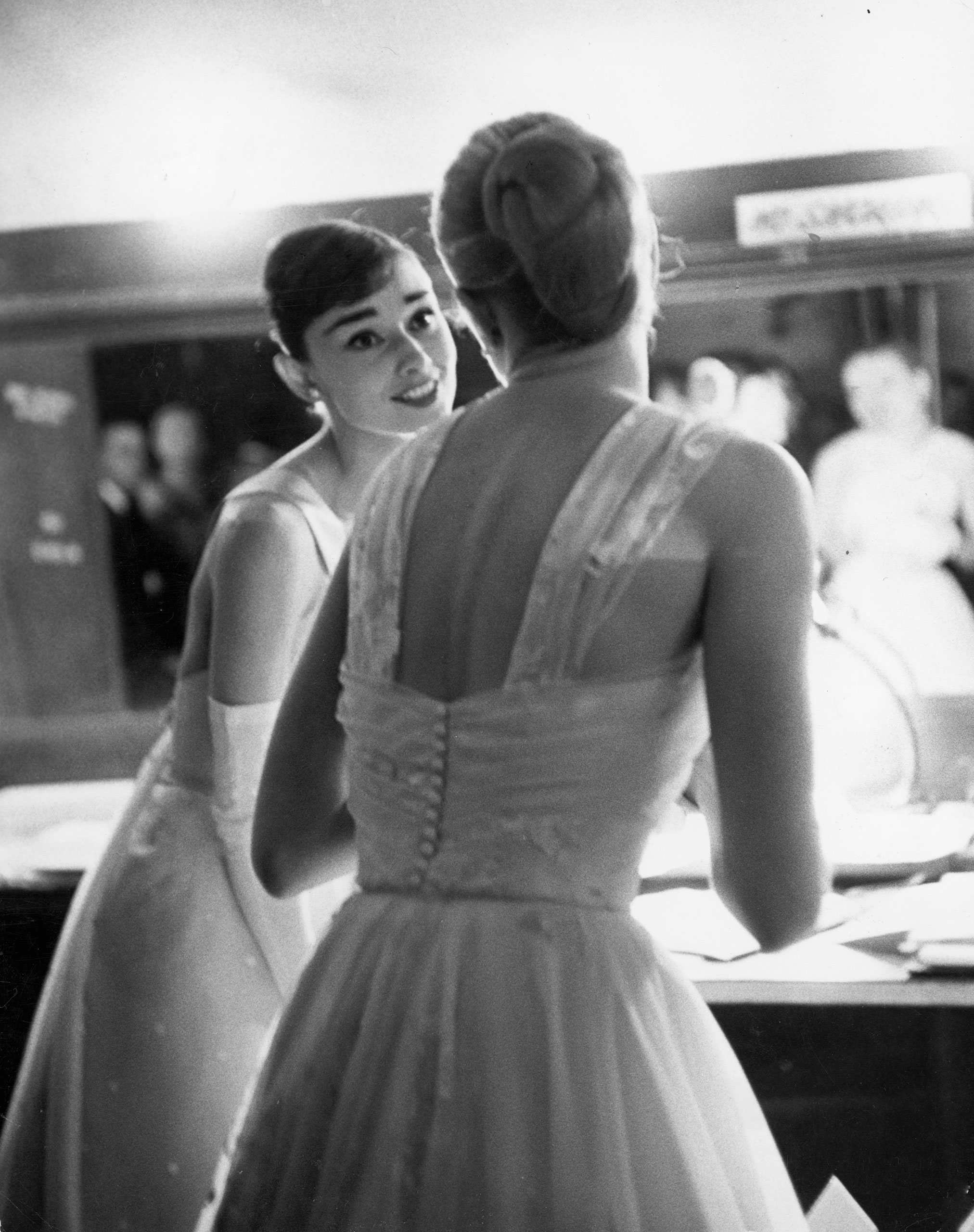 Audrey Hepburn and Grace Kelly backstage at the RKO Pantages Theatre during the 28th Annual Academy Awards, 1956.