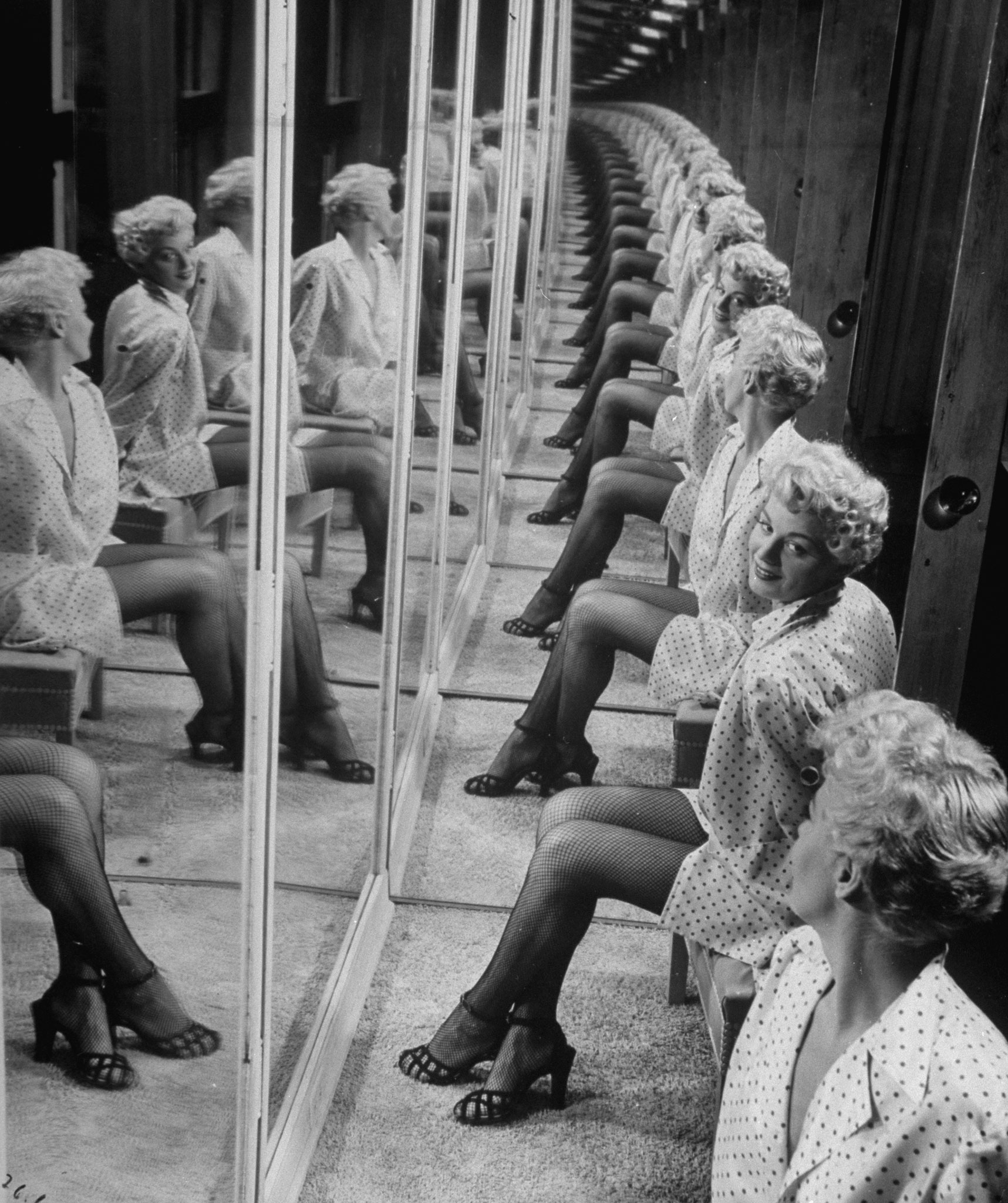 Shelley Winters in a booth with mirrors, 1949.