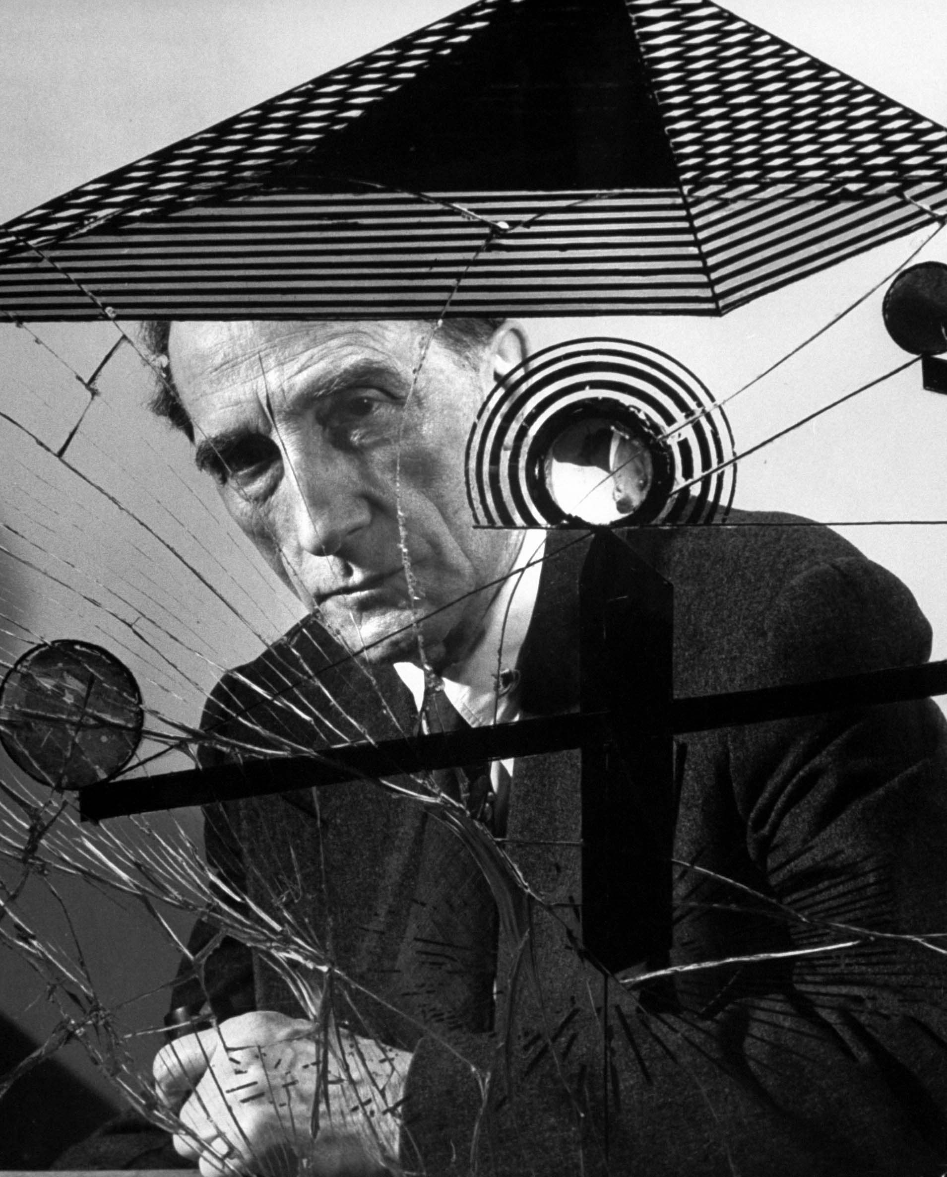 Marcel Duchamp with Dada artwork, 1953.