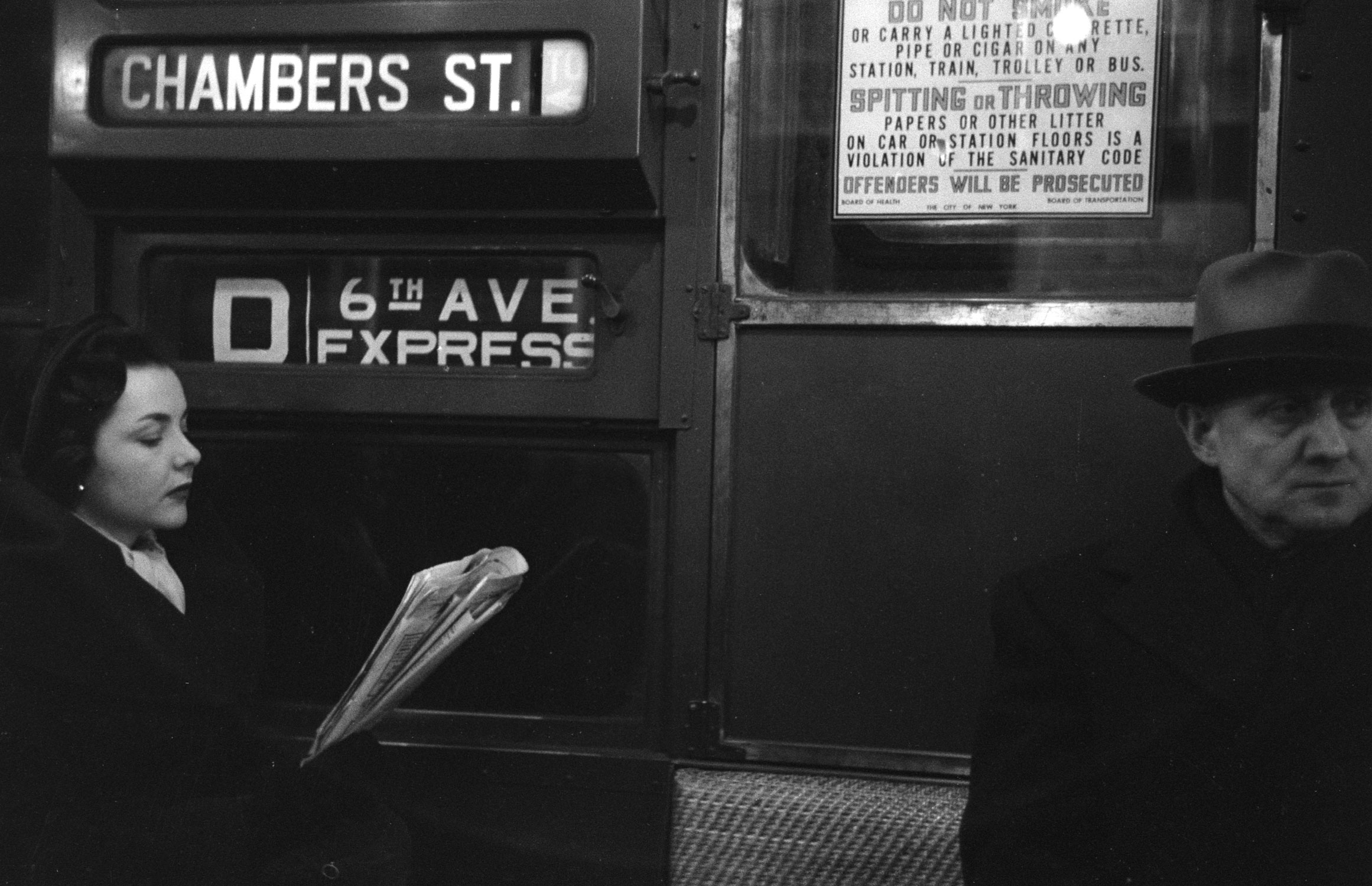 Young woman riding the D train, 1951.