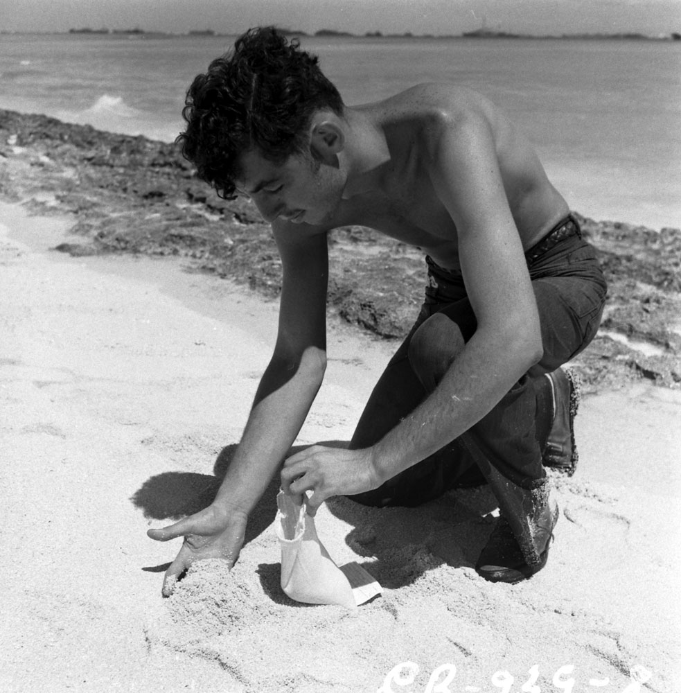 Gathering sand for radiation exposure testing, 1946.