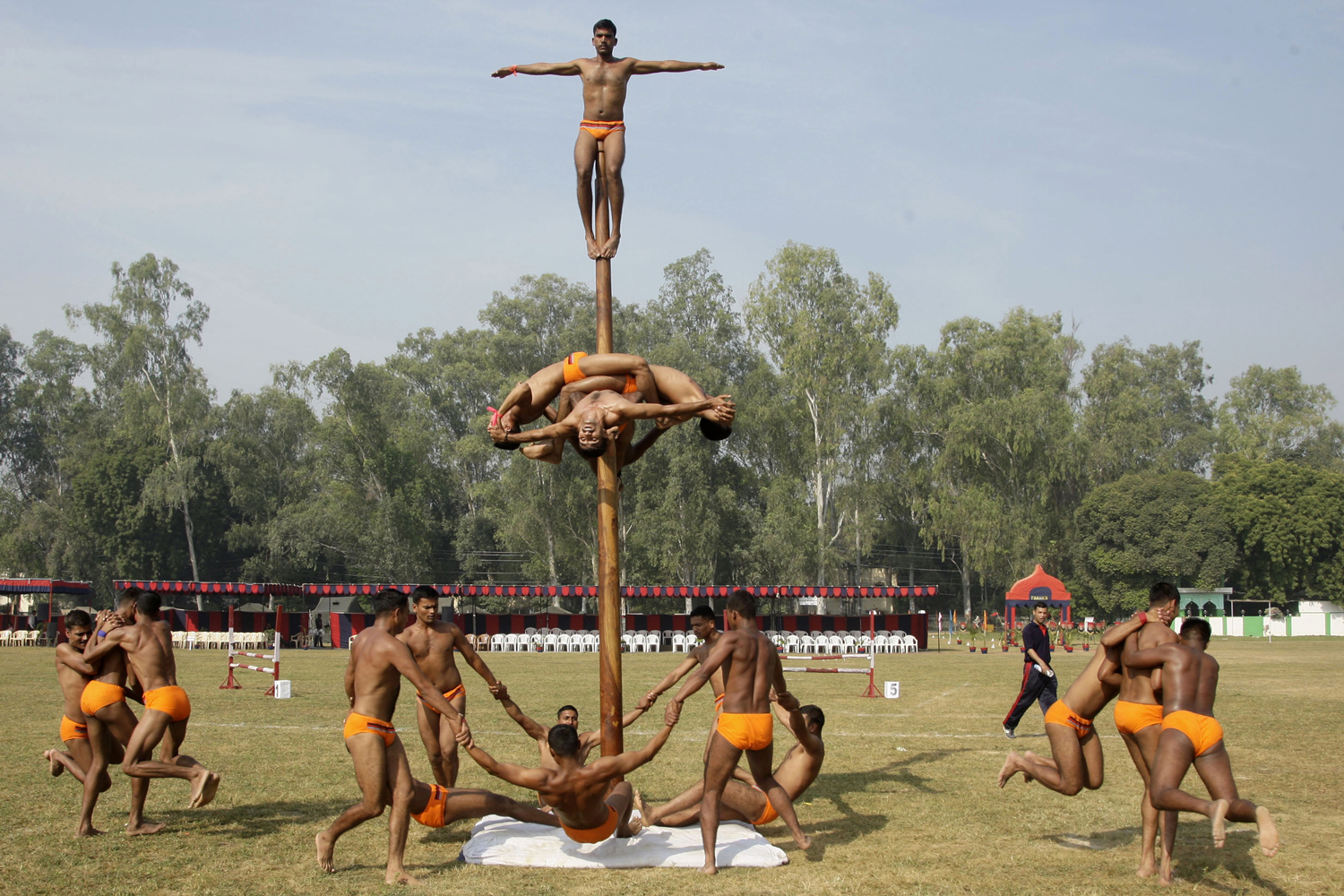 Image: Oct. 21, 2012. Indian soldiers perform Malkhamb, a traditional Indian sport in which a gymnast performs on a wooden pole, during a two day Army exhibition in Allahabad.