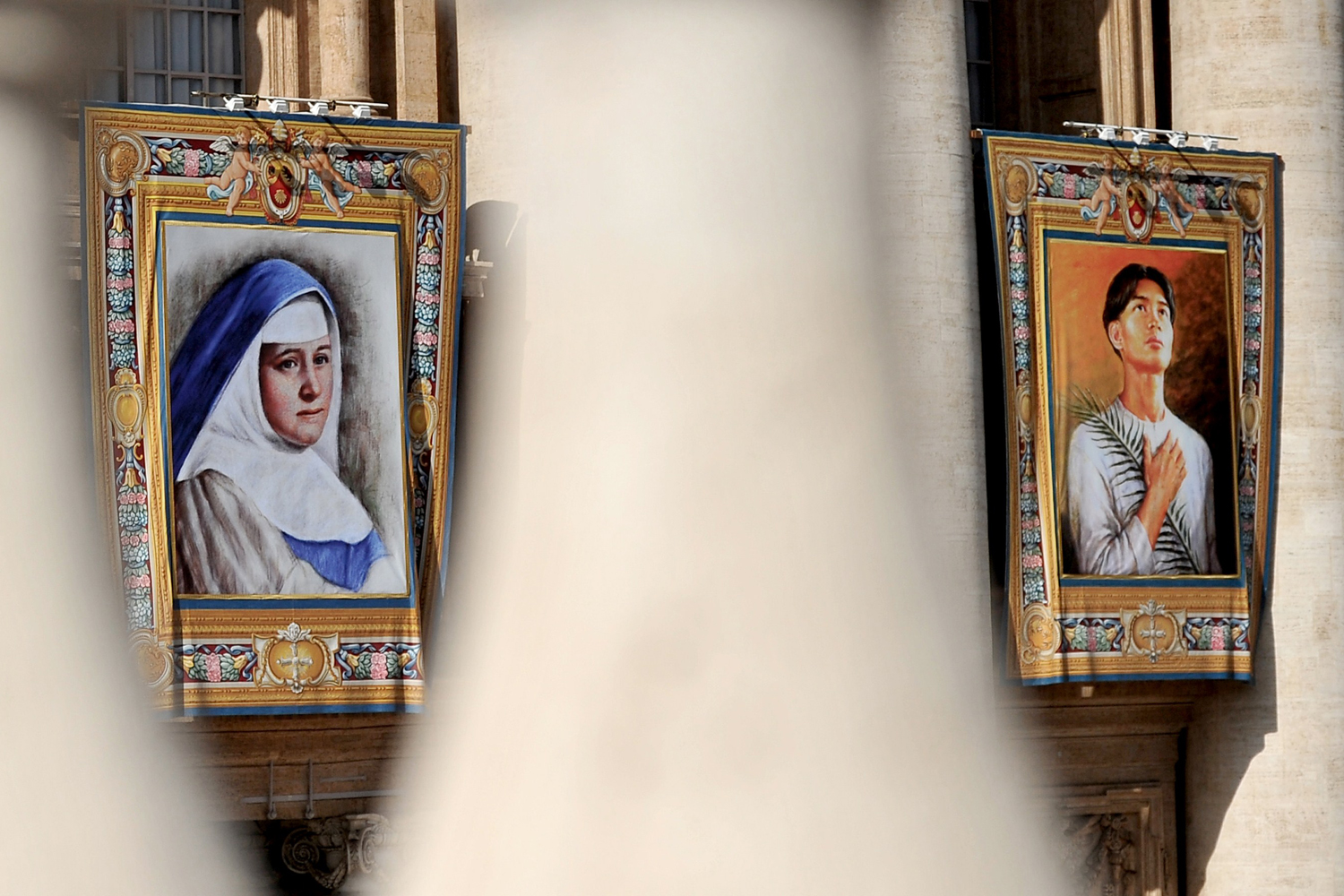 Image: Oct. 21, 2012. Tapestries of Maria del Carmen and Pedro Calungsod hang on St. Peter's Basilica during a special mass to name seven new saints in St Peter's square in the Vatican City.