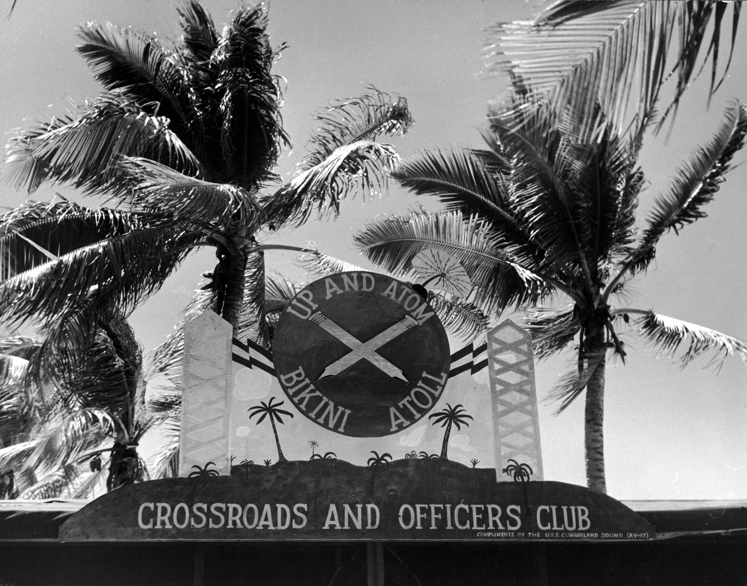 The sign atop the Officers' Club at the Bikini Atoll station (reading "Up and Atom"), 1946.
