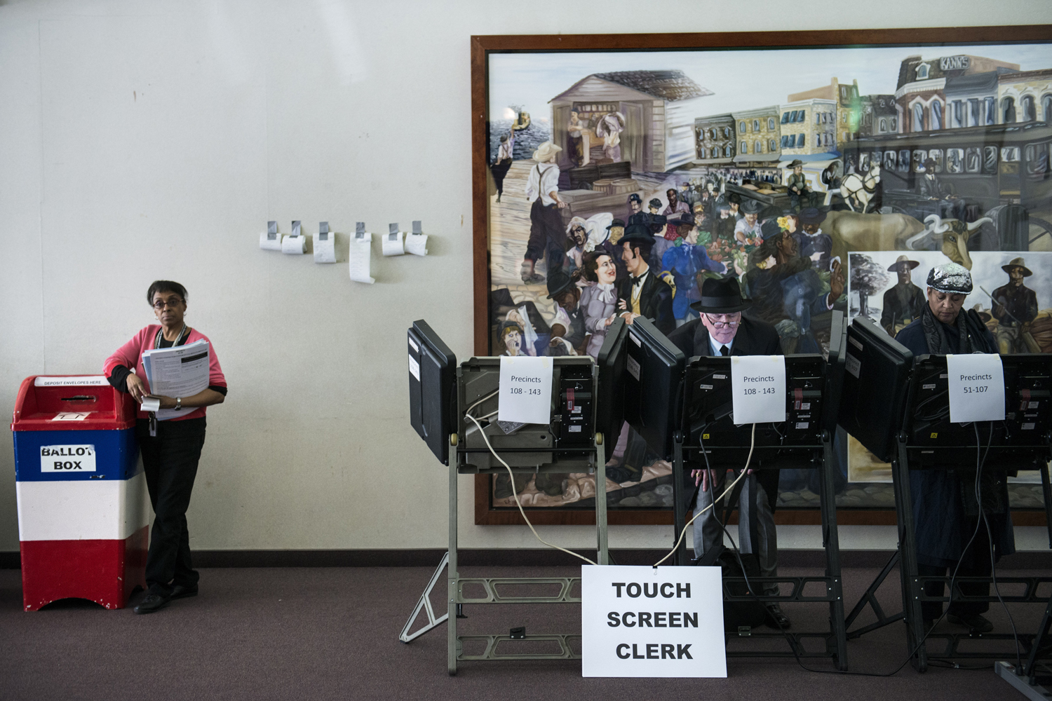 Image: Oct. 22, 2012. DC Board of Elections worker Linda Johnson waits as voters cast their ballots on electronic voting machines during the first day of early voting in Washington, DC.