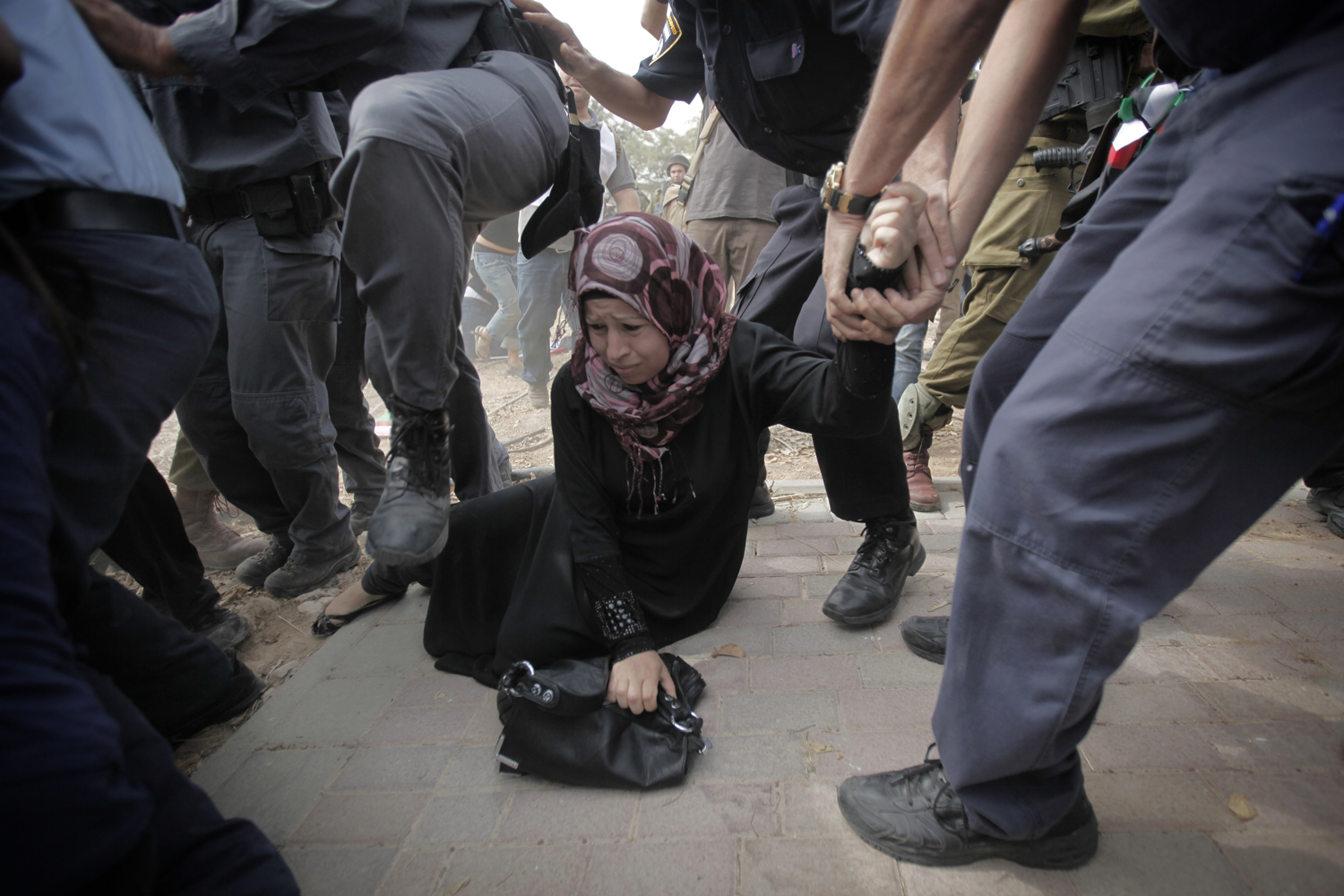 Image: Oct. 24, 2012. A Palestinian activist is arrested by Israeli soldiers as dozens of Palestinians block the entrance of the Rami Levy supermarket opened in the Shaar Binyamin Jewish settlement close to the city of Ramallah in the Israeli occupied Palestinian West Bank.