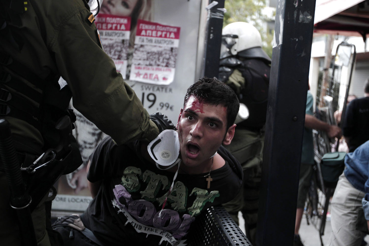 Oct. 9, 2012. Protesters clash with riot policemen in front of the Parliament building in Athens. German Chancellor Angela Merkel praised the Greek government for making progress in implementing tough reforms and said more could be done to reduce the country's deficit. As the two leaders met, police clashed with protesters angry at painful austerity measures for which they blame Merkel.
