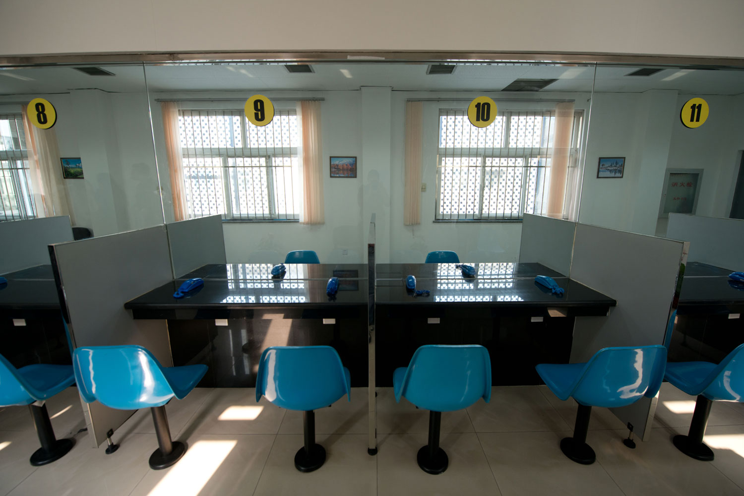 Image: This general view shows a room where inmates can meet with visitors inside the No. 1 Detention Center during a government guided tour in Beijing. The rare visit to the facility, which has capacity for 1,000 inmates, was opened to the foreign media as Beijing prepares for the 18th Congress of the Communist Party of China.