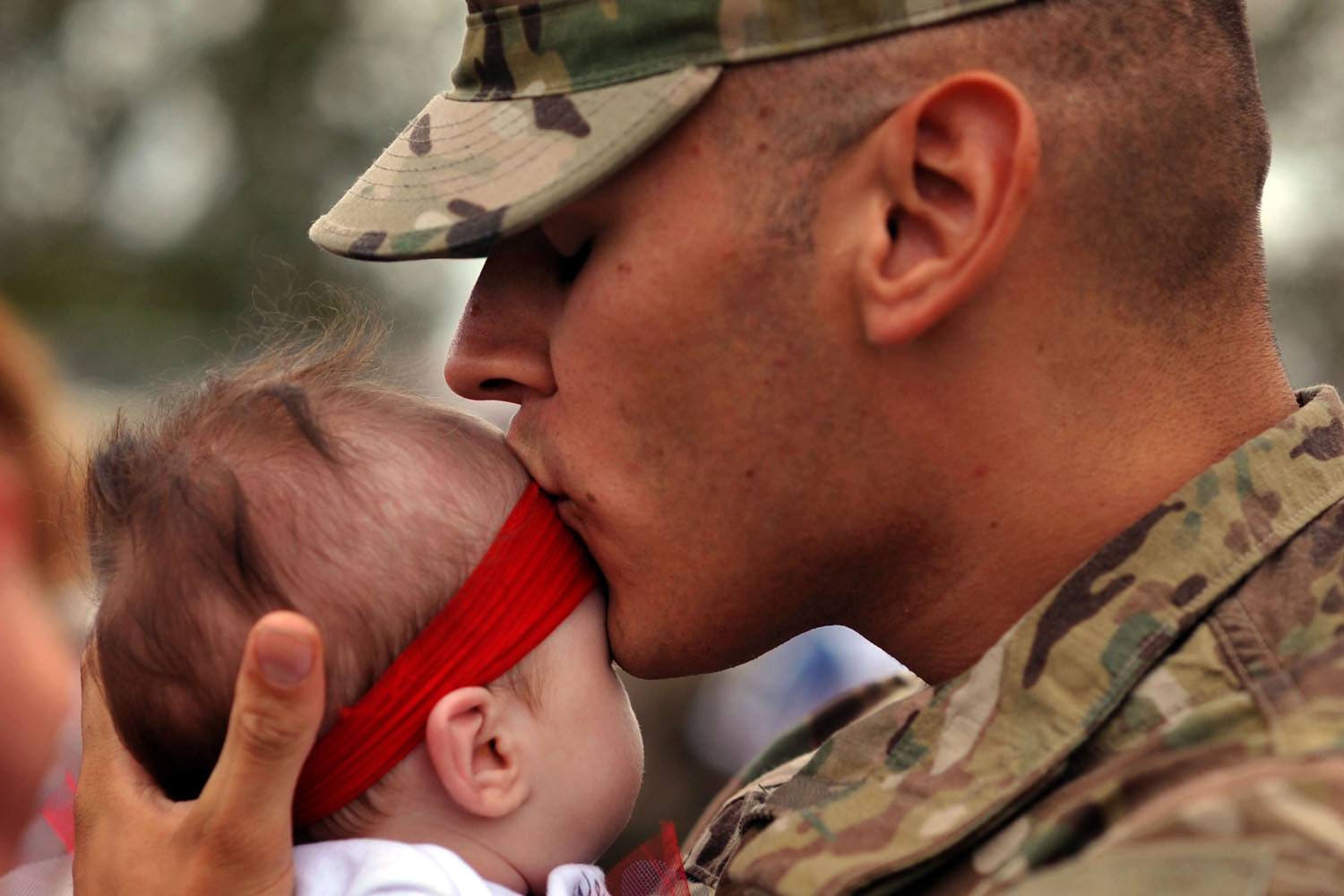 Oct. 10, 2012. Army Spc. Cory Allen kisses his daughter, Lacey Allen, during a welcome home ceremony for soldiers from the Army's 1st Battalion, 30th Infantry Regiment, at Fort Stewart, Ga. One hundred troops returned home after their first deployment to Afghanistan.