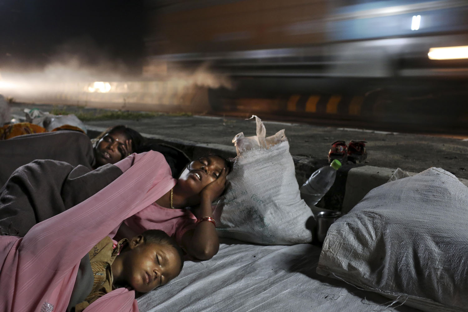 Oct. 8, 2012. An Indian child rests with landless farmers as they stop for the night, during the  Jan Satyagraha  march to New Delhi to highlight the problems of India's landless, near Agra, India.