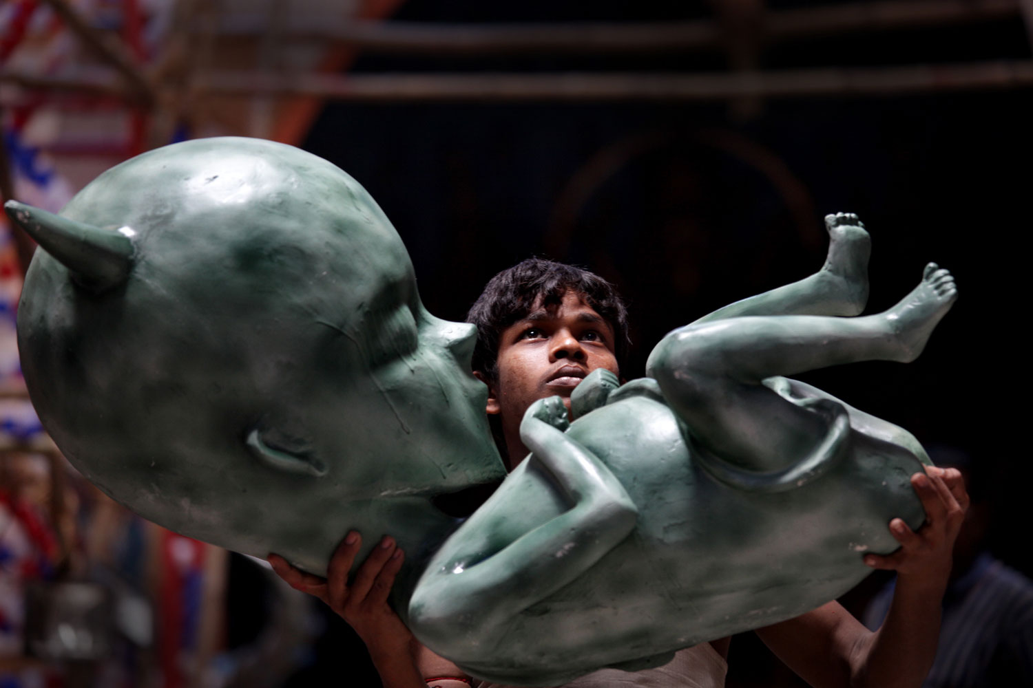 Oct. 12, 2012. An element of a Goddess Durga idol representing an embryo of demon is installed by Indian artist Mukunda Mondal at a makeshift pandal in Calcutta, India, ahead of the Durga Puja festival.