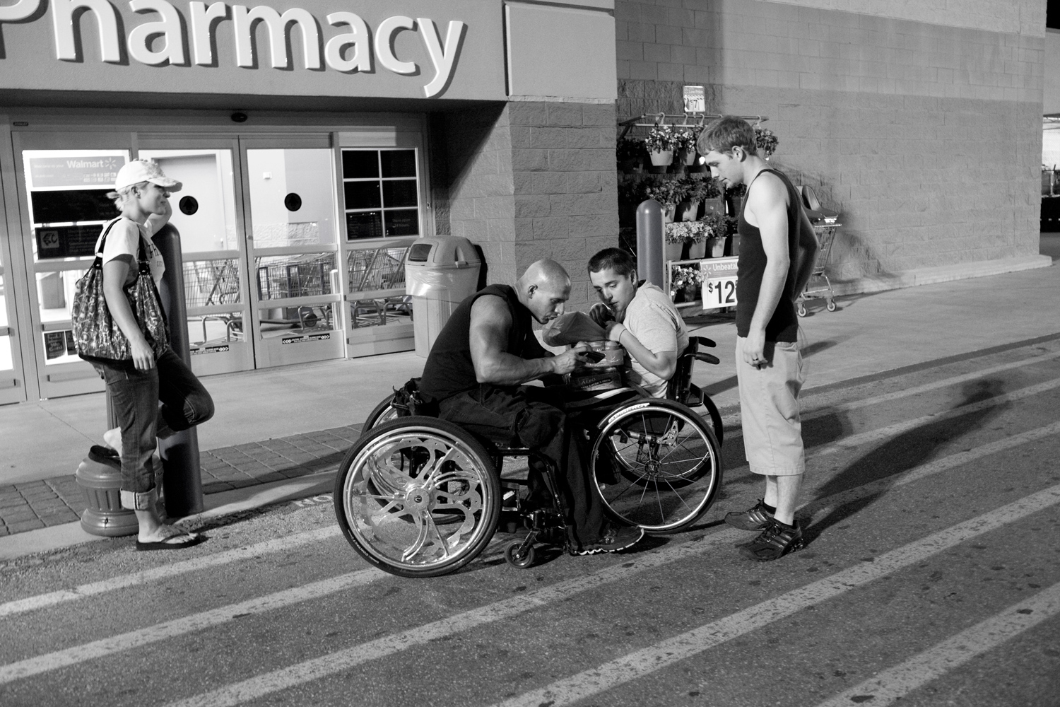 Nick Scott talks to a fan outside of a Walmart in Austin. Scott was shopping for a battery to power his light-up wheelchair when the young man expressed an interest in getting involved with the sport.