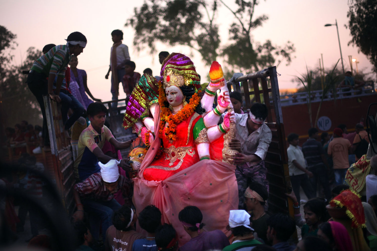 Image: Oct. 24, 2012. Hindu devotees unload an idol of the Hindu goddess Durga for immersion into the Yamuna river during Durga Puja festivities in New Delhi, India.