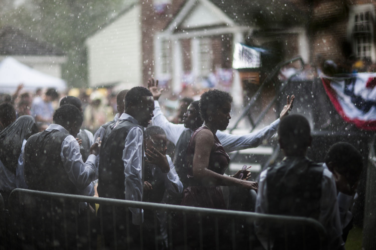 Image: A high school choir gets soaked in a downpour before a campaign rally for President Obama in Glen Allen, Va. July 14, 2012.