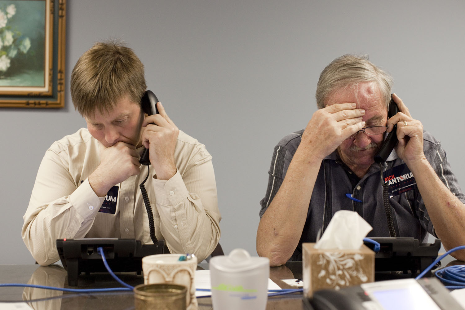 Image: Volunteers Paul J. Besse (L) and Bruce Donelly make evening phone calls to Louisiana residents at Rick Santorum's Louisiana campaign headquarters in Jefferson Parish, Metairie, La. March 19, 2012.