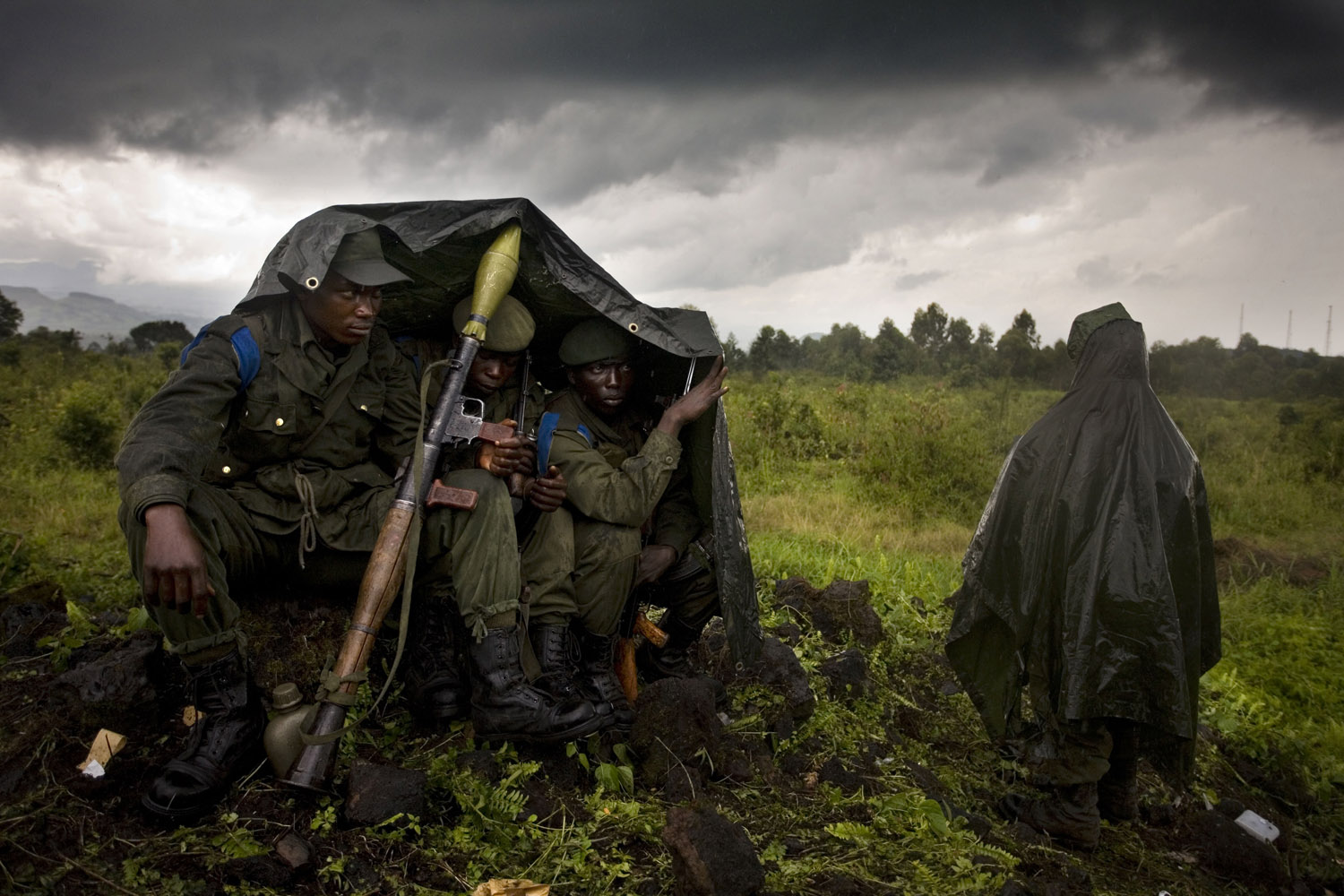 2005: Dominic NahrNorth Kivu, Kibati, Democratic Republic of the Congo, 2008. Four Congolese government soldiers shelter from the rain on the front line about five kilometers north of Kibati. CNDP Rebels and government soldiers are separated by less then half a kilometer and fighting flares up regularly.
                               I remember how I felt proud to be a part of such a great group of people—photographers who truly believe in what they are doing. Even though our community is small, we remember the ones who came before us with great pride and we take care or are taken care of by the ones who are still around.
                              When the balloons flew for the fallen photographers I really felt a strong feeling of responsibility to the years that were ahead of me. The workshop gave me an opportunity to see what was out there, from stories to all the editors. In the years that followed I knew I had to produce strong untold stories, and with these essays push my work out the same way we had done at the workshop.Half the battle is making the images, the other half is showing up and making sure they find their way to the surface.