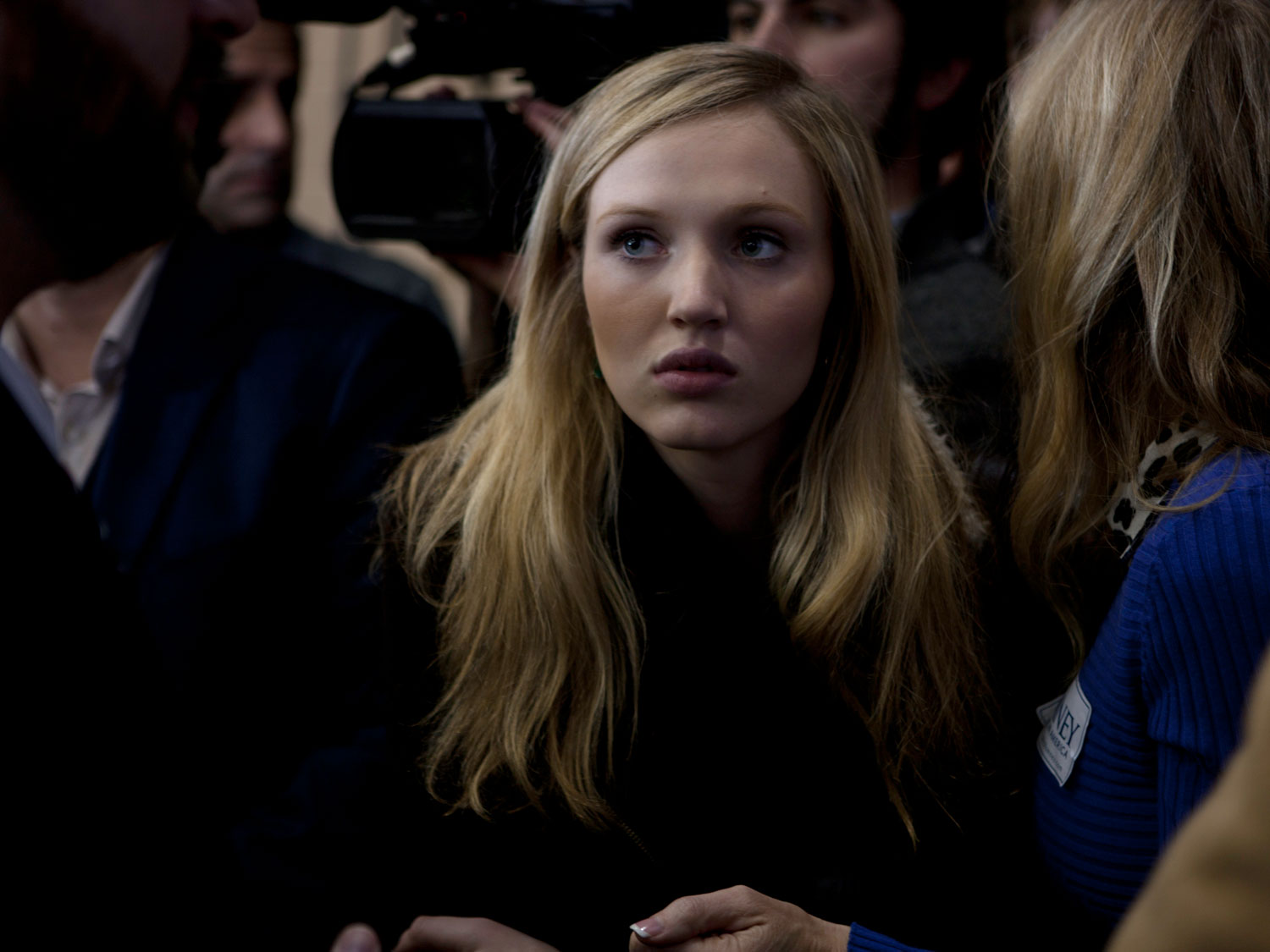 Image: A young woman listens to Mitt Romney during a rally with New Jersey Governor Chris Christie at Exeter High School in Exeter, N.H. Jan. 8, 2012.