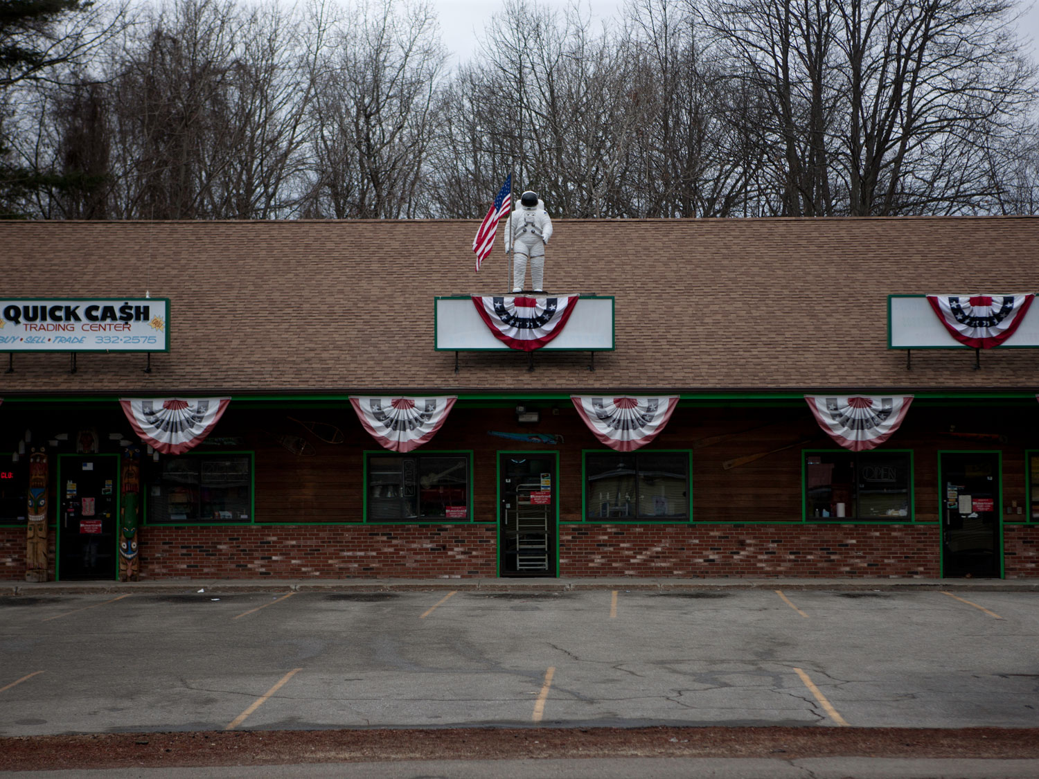 Image: Flags decorate a strip mall near Rochester, N.H. just days before the primary election. Jan. 8, 2012.